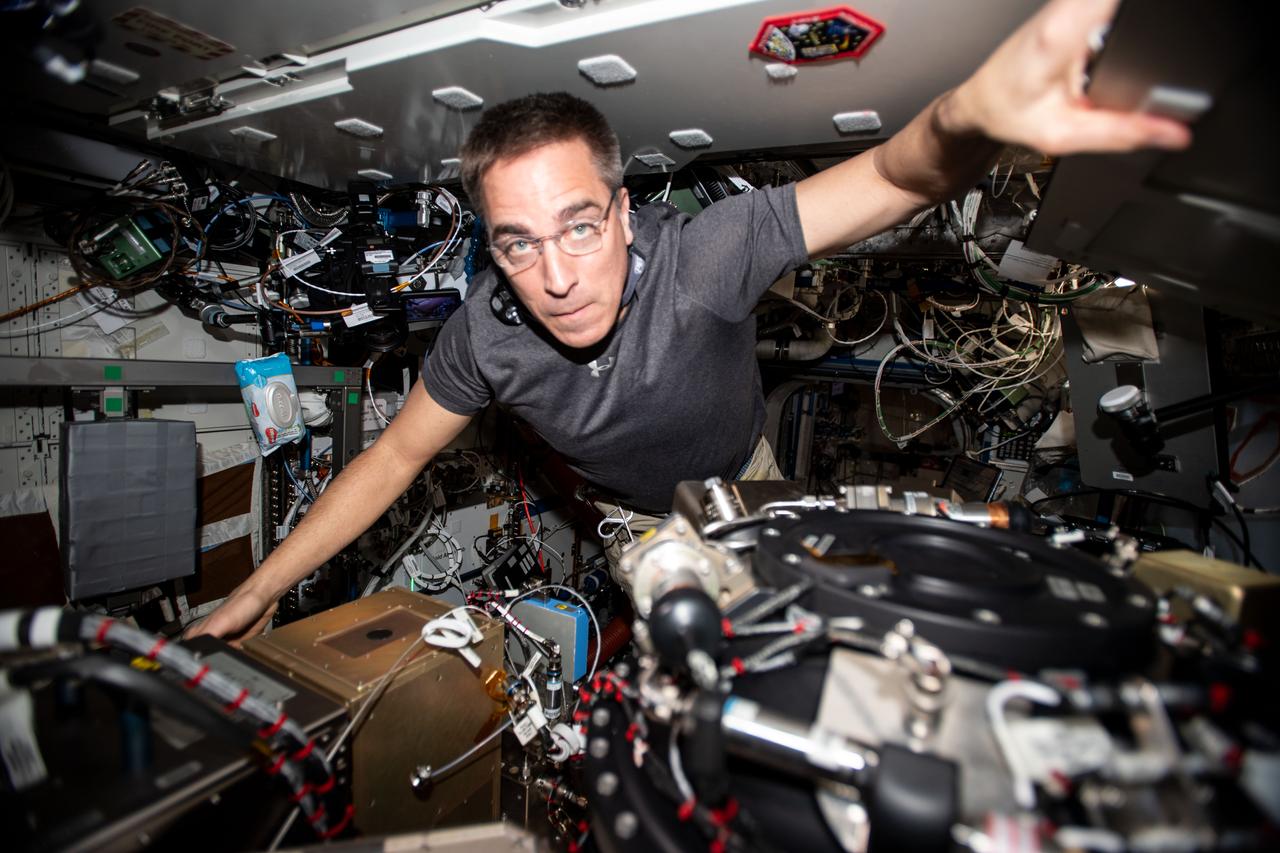iss063e002821 (April 23, 2020) --- NASA astronaut and Expedition 63 Commander Chris Cassidy performs maintenance on the Combustion Integrated Rack, a research device that enables safe fuel, flame and soot studies in microgravity.