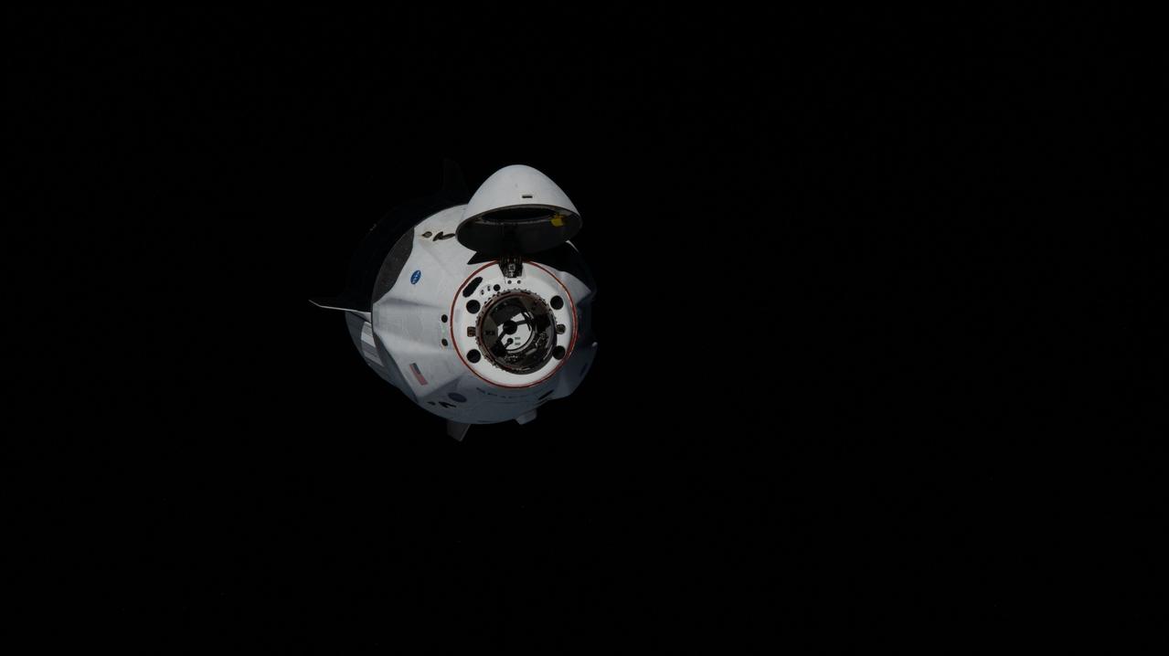 iss063e021460 (May 31, 2020) --- Astronauts Doug Hurley and Bob Behnken of NASA's Commercial Crew Program were aboard the SpaceX Crew Dragon as it approached the International Space Station. The Crew Dragon's nose cone is open revealing the spacecraft's docking mechanism that would connect to the Harmony module's forward International Docking Adapter.