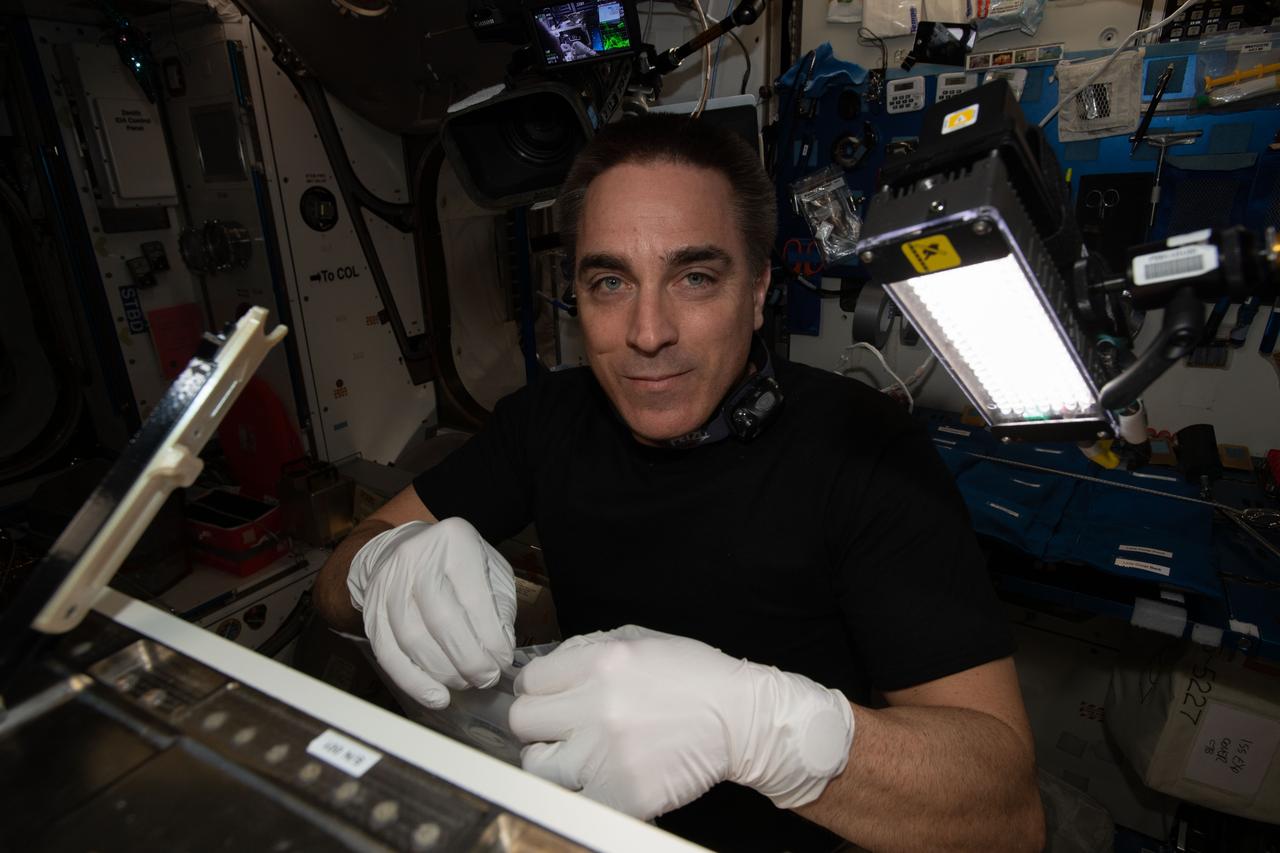 iss063e026157 (June 11, 2020) --- NASA astronaut and Expedition 63 Commander Chris Cassidy configures the new Spectrum imager that will view the cellular growth of plants in multiple wavelengths.