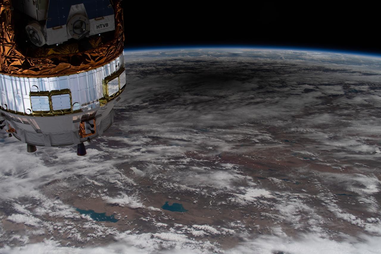 iss063e031763 (June 21, 2020) --- The International Space Station was orbiting above China when this picture of the solar eclipse shadowing a portion of the Asian continent was captured by an external high definition camera. In the left foreground, is the Progress 74 resupply ship from Russia.