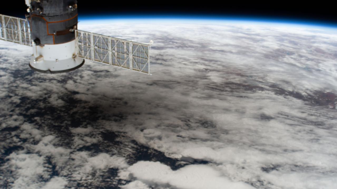iss063e031864 (June 21, 2020) --- The International Space Station was orbiting above China when this picture of the solar eclipse shadowing a portion of the Asian continent was captured by an external high definition camera. In the left foreground, is the Progress 74 resupply ship from Russia.