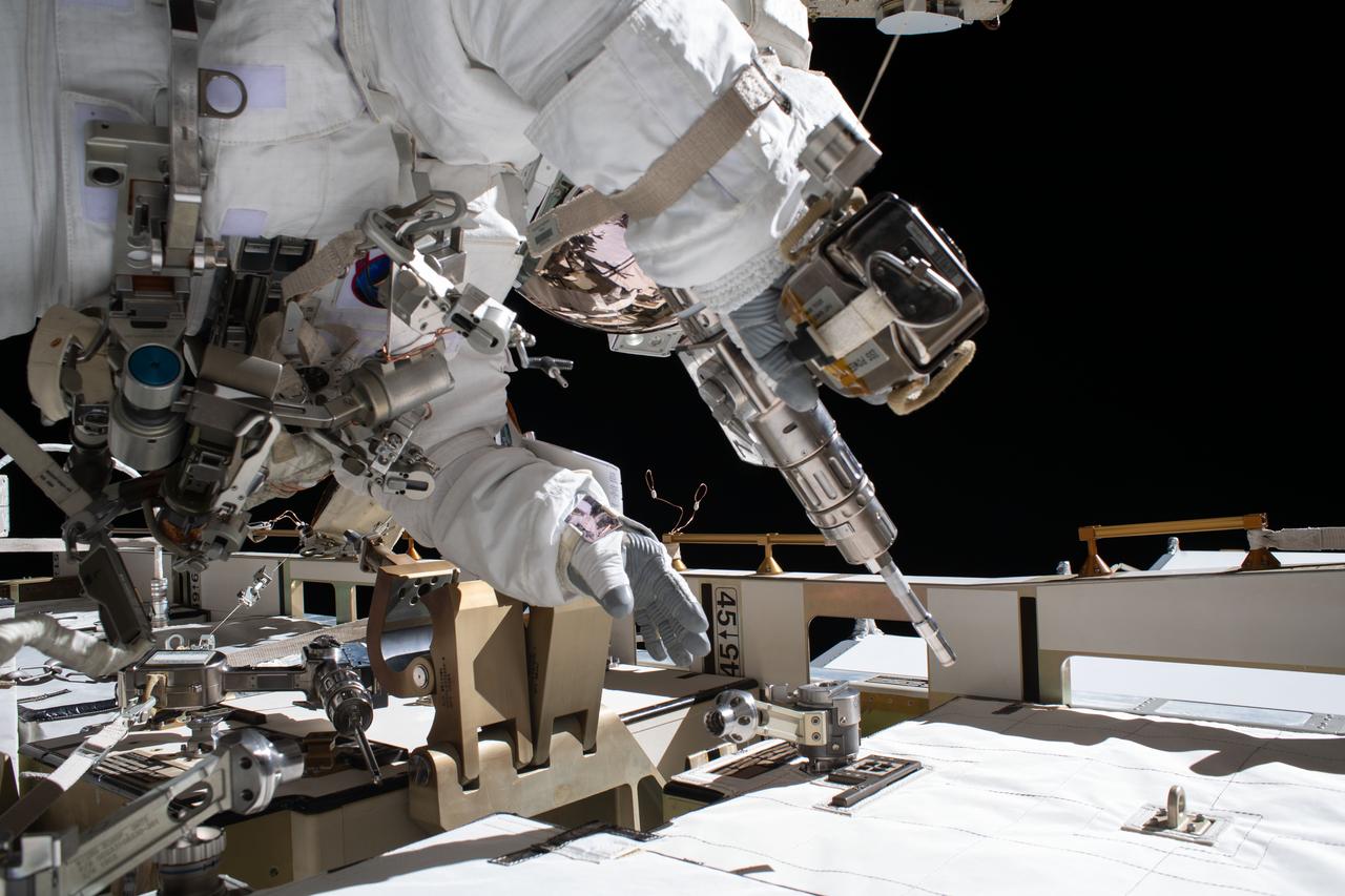 iss063e034013 (July 1, 2020) --- NASA astronaut and Expedition 63 Flight Engineer Bob Behnken works during a six-hour and one-minute spacewalk to swap an aging nickel-hydrogen battery for a new lithium-ion battery on the International Space Station's Starboard-6 truss structure. Behnken is pictured holding a pistol grip tool he used to remove and attach bolts that hold the batteries in place.