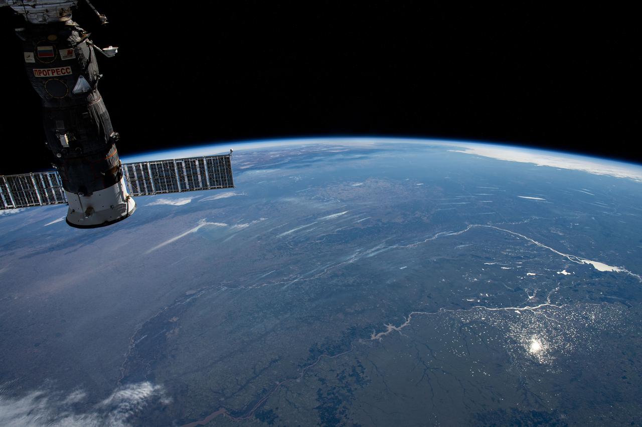 iss063e040037 (July 3, 2020) --- This photograph of the Earth's horizon looks back towards Uruguay as the International Space Station orbited just off the coast of the South American nation. The Progress 75 cargo craft from Russia is pictured in the left foreground.
