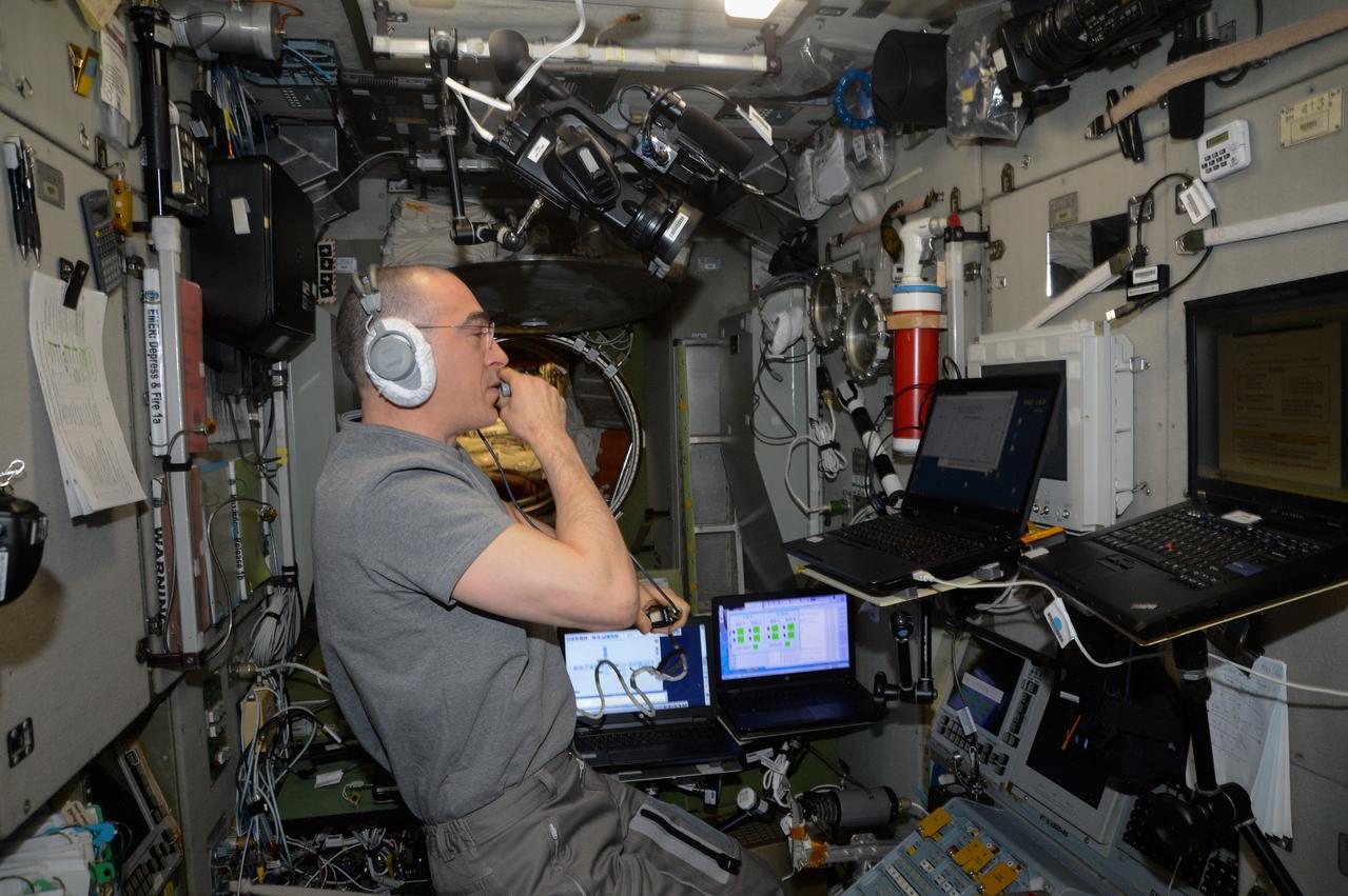 iss063e041647 (July 9, 2020) --- Roscosmos Flight Engineer Anatoly Ivanishin practices a simulated emergency evacuation of the International Space Station on a computer inside the Zvezda service module. Ivanishin spent the afternoon reviewing procedures for quickly entering the Soyuz MS-16 crew ship for a rapid undocking and Earth re-entry with crewmates Ivan Vagner of Roscosmos and Chris Cassidy of NASA (both out of frame).