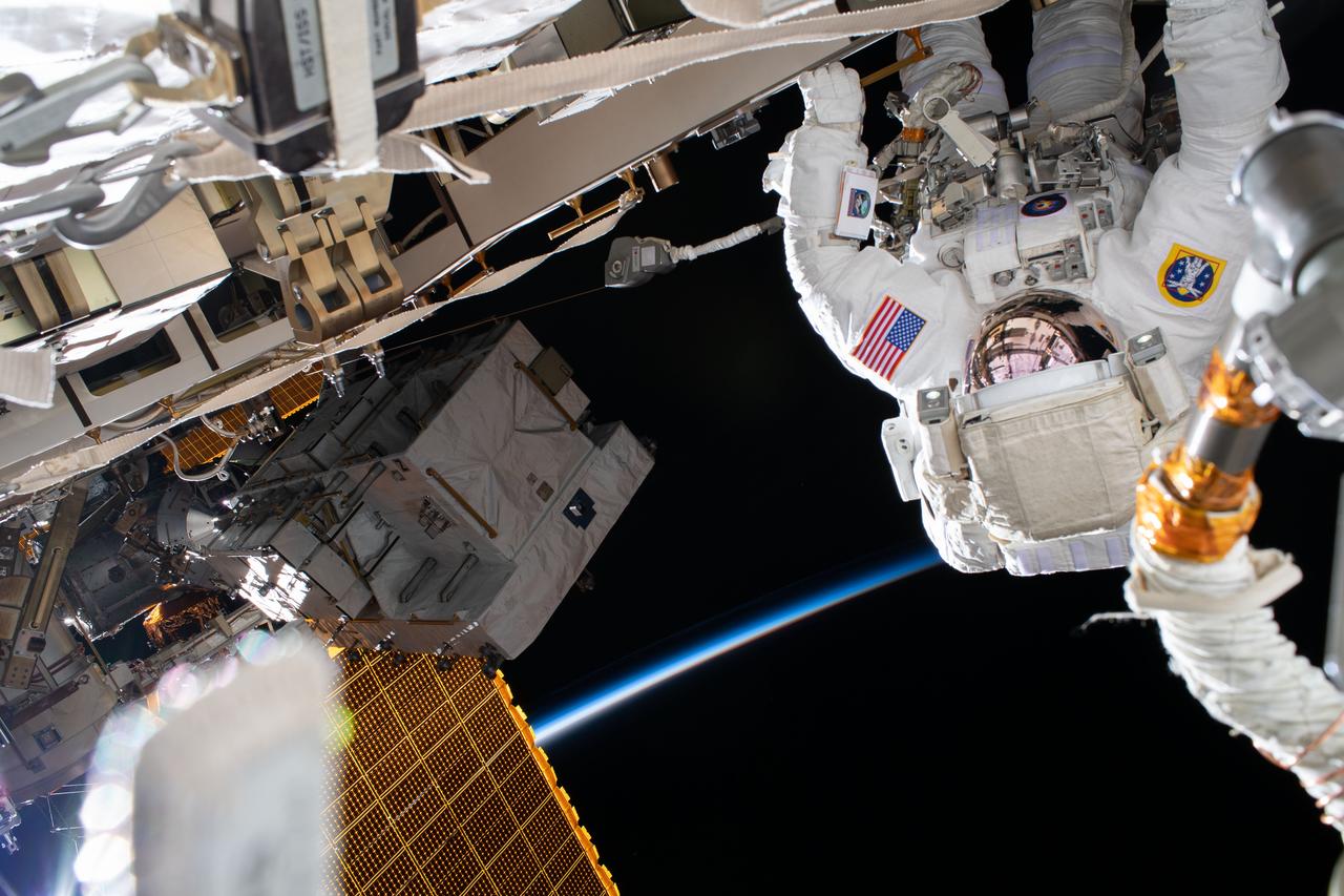 iss063e049941 (July 16, 2020) --- NASA astronaut Chris Cassidy works during a six-hour spacewalk to install three lithium-ion batteries on the International Space Station's truss structure. The orbiting lab was above the North Pacific Ocean off the coast of Russia flying into an orbital sunrise at the time this photograph was taken.