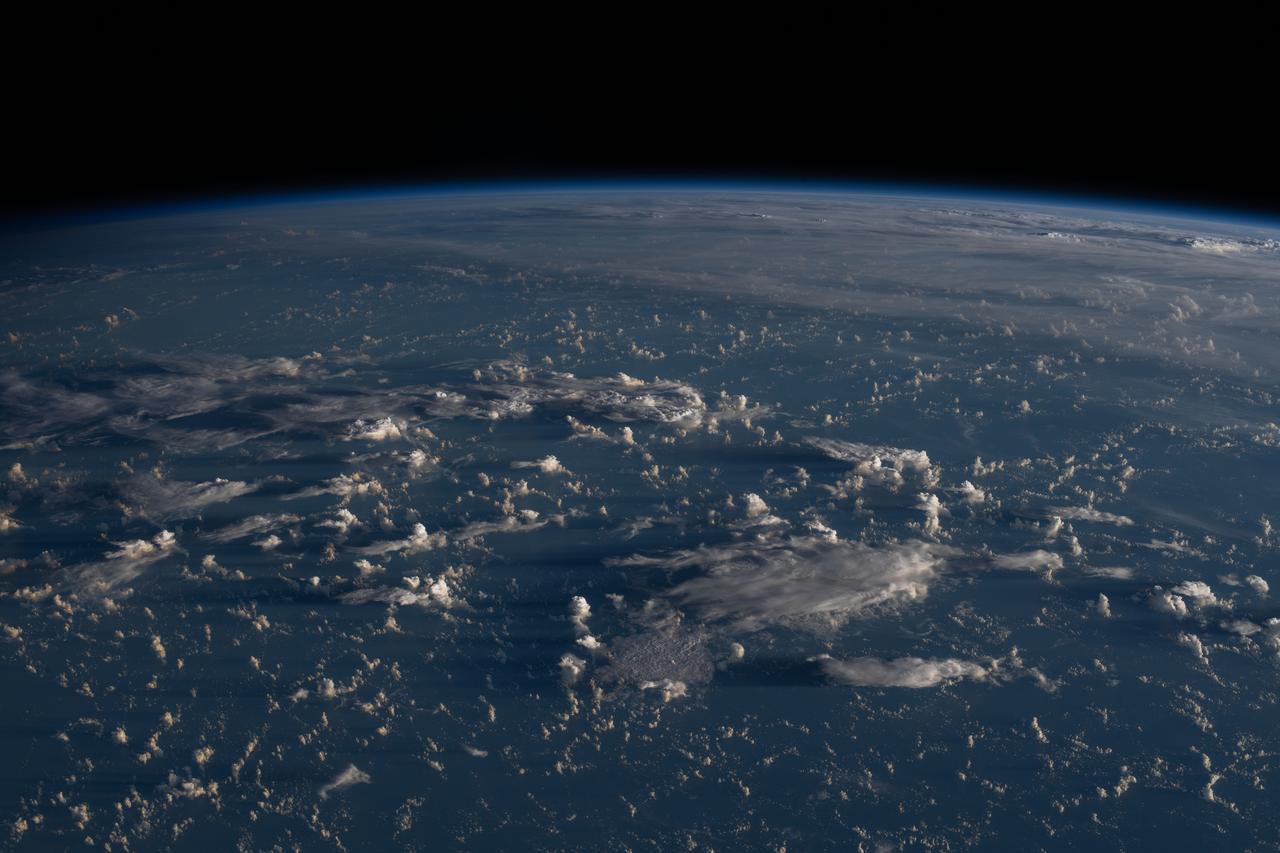iss063e052774 (July 13, 2020) --- Sunrise casts long shadows from the clouds across the Philippine Sea as the International Space Station orbited about 200 miles east of Taiwan.