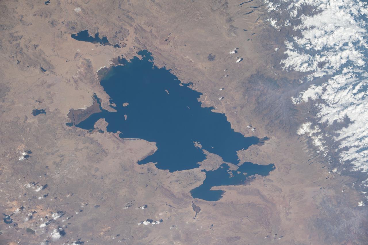 iss063e053023 (July 22, 2020) --- Lake Titicaca, pictured from the International Space Station as it orbited off the Pacific coast of South America, is located between the nations of Peru and Bolivia in the Andes Mountains and is one of the highest navigable lakes in the world.