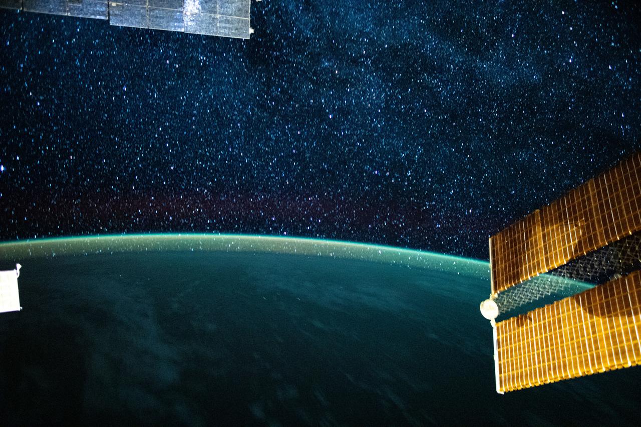 iss063e058447 (July 24, 2020) --- This long-exposure photograph from the International Space Station was taken during an orbital night period and reveals the Milky Way glittering above a bright but exaggerated atmospheric glow blanketing the Earth's horizon.
