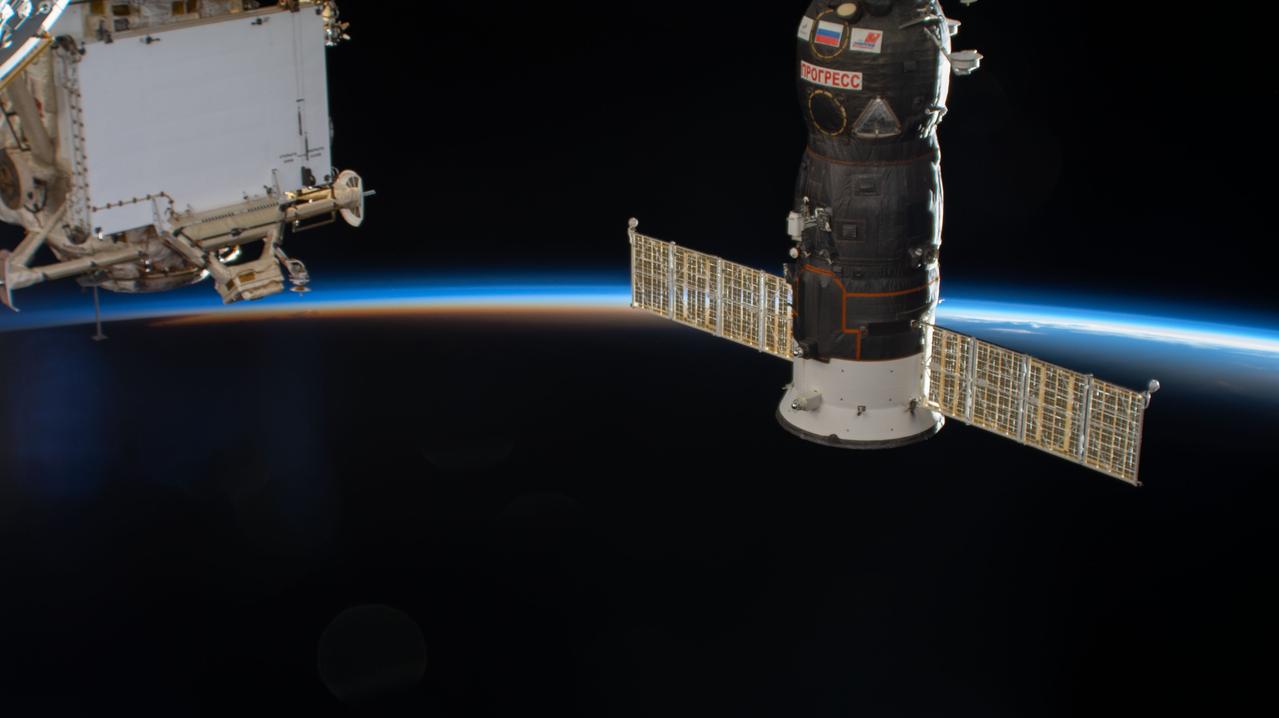 iss063e066603 (Aug. 6, 2020) --- The International Space Station soars into an orbital sunset over the Atlantic Ocean near Bermuda. Russia's Progress 76 resupply ship pictured is in the foreground docked to the Pirs docking compartment.