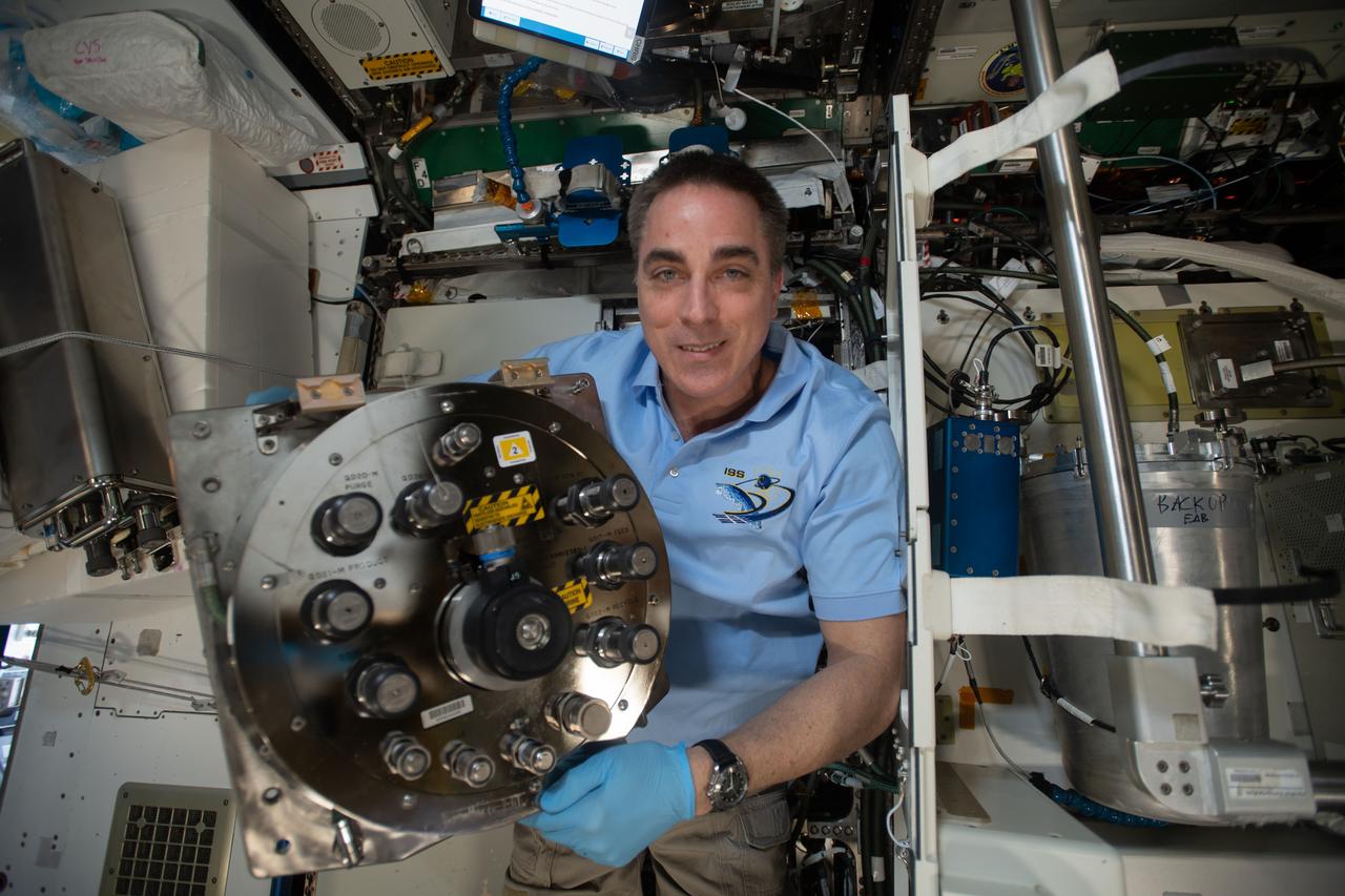 iss063e087568 (Sept. 10, 2020) --- NASA astronaut and Expedition 63 Commander Chris Cassidy replaces components inside the Waste and Hygiene Compartment, the International Space Station's bathroom located inside the Tranquility module.