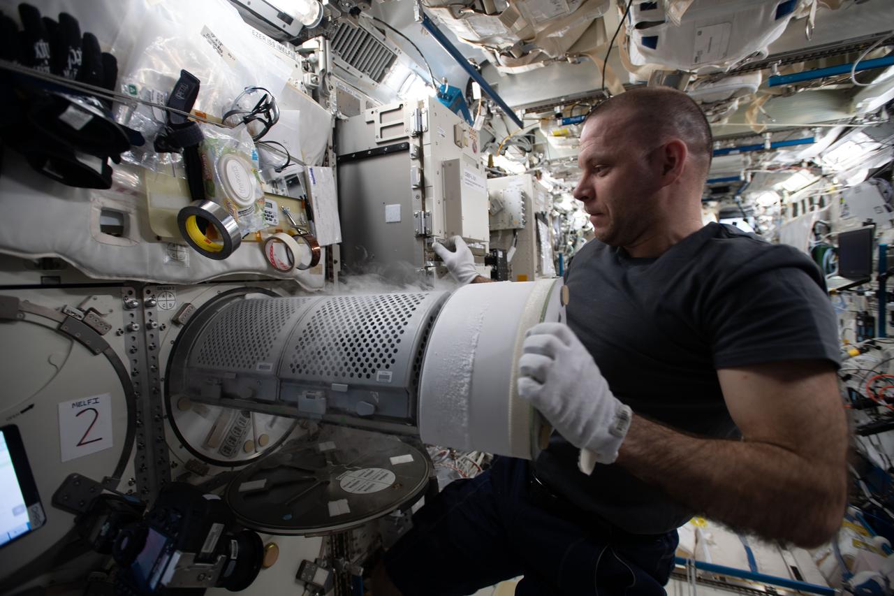 iss063e104373 (Oct. 7, 2020) --- Roscosmos cosmonaut and Expedition 63 Flight Engineer Ivan Vagner transfers biological samples into a science freezer for stowage and later analysis aboard the International Space Station.