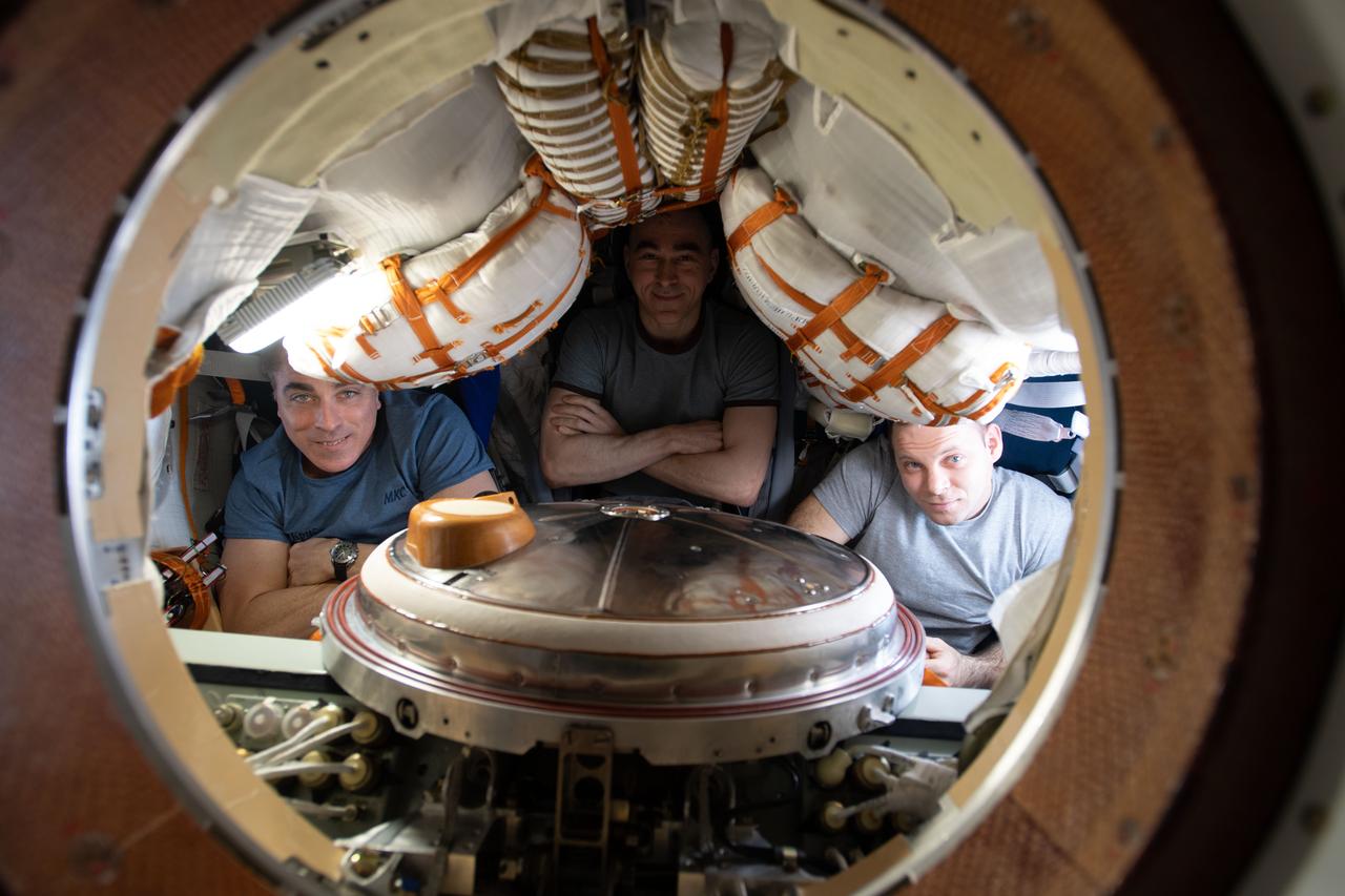 iss063e113857 (Oct. 21, 2020) --- Expedition 63 crewmates (from left) Chris Cassidy of NASA and Roscosmos cosmonauts Anatoly Ivanishin and Ivan Vagner are seated inside the Soyuz MS-16 crew ship moments before the hatches were closed to the International Space Station. The trio would parachute to Earth inside the Soyuz' descent module several hours later.