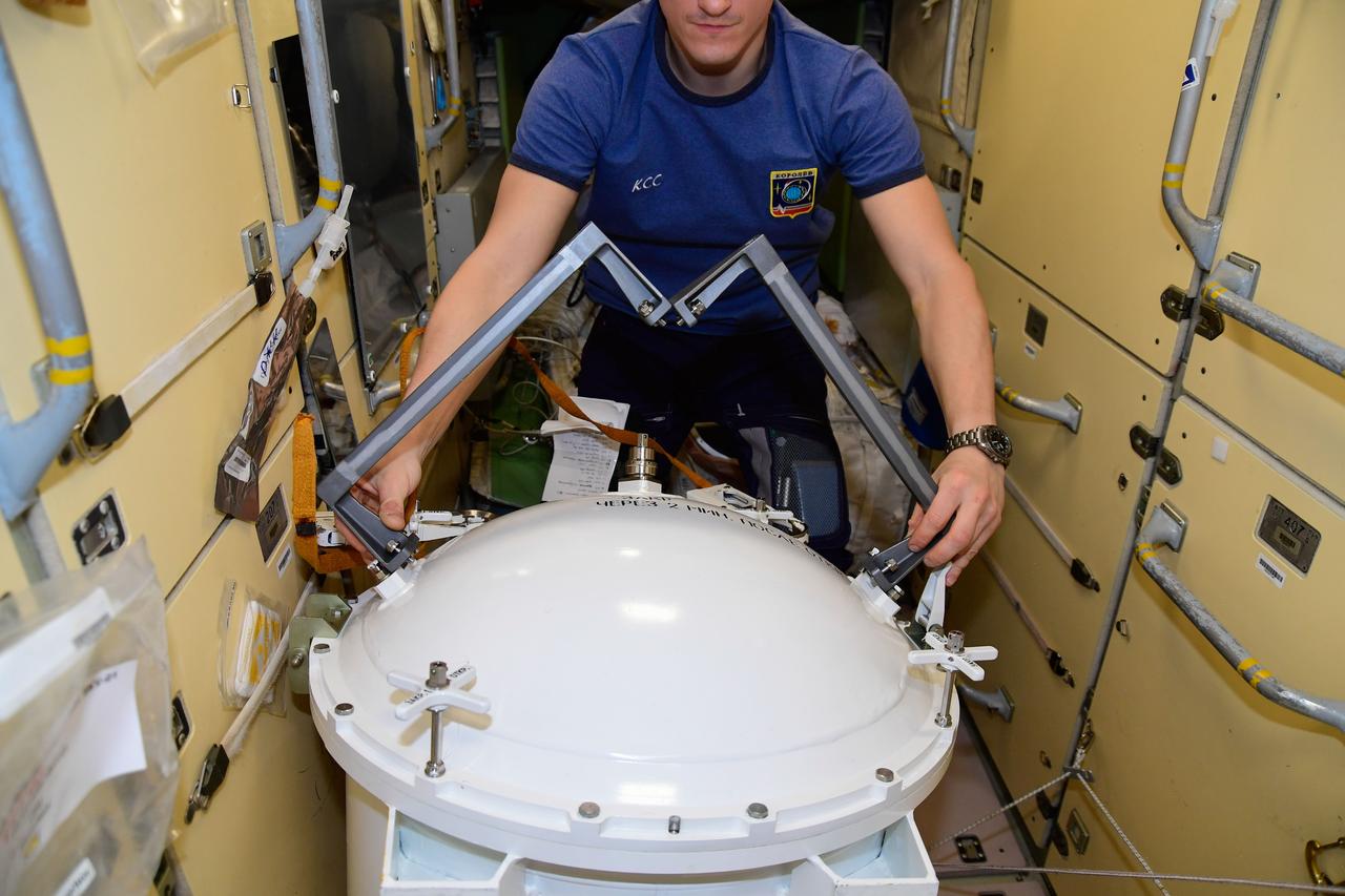 iss064e003159 (Nov. 4, 2020) --- Roscosmos cosmonaut and Expedition 64 Flight Engineer Sergey Kud-Sverchkov checks out spacewalking hardware ahead of a Russian spacewalk that he and Commander Sergey Ryzhikov (out of frame) conducted on Nov. 18, 2020.