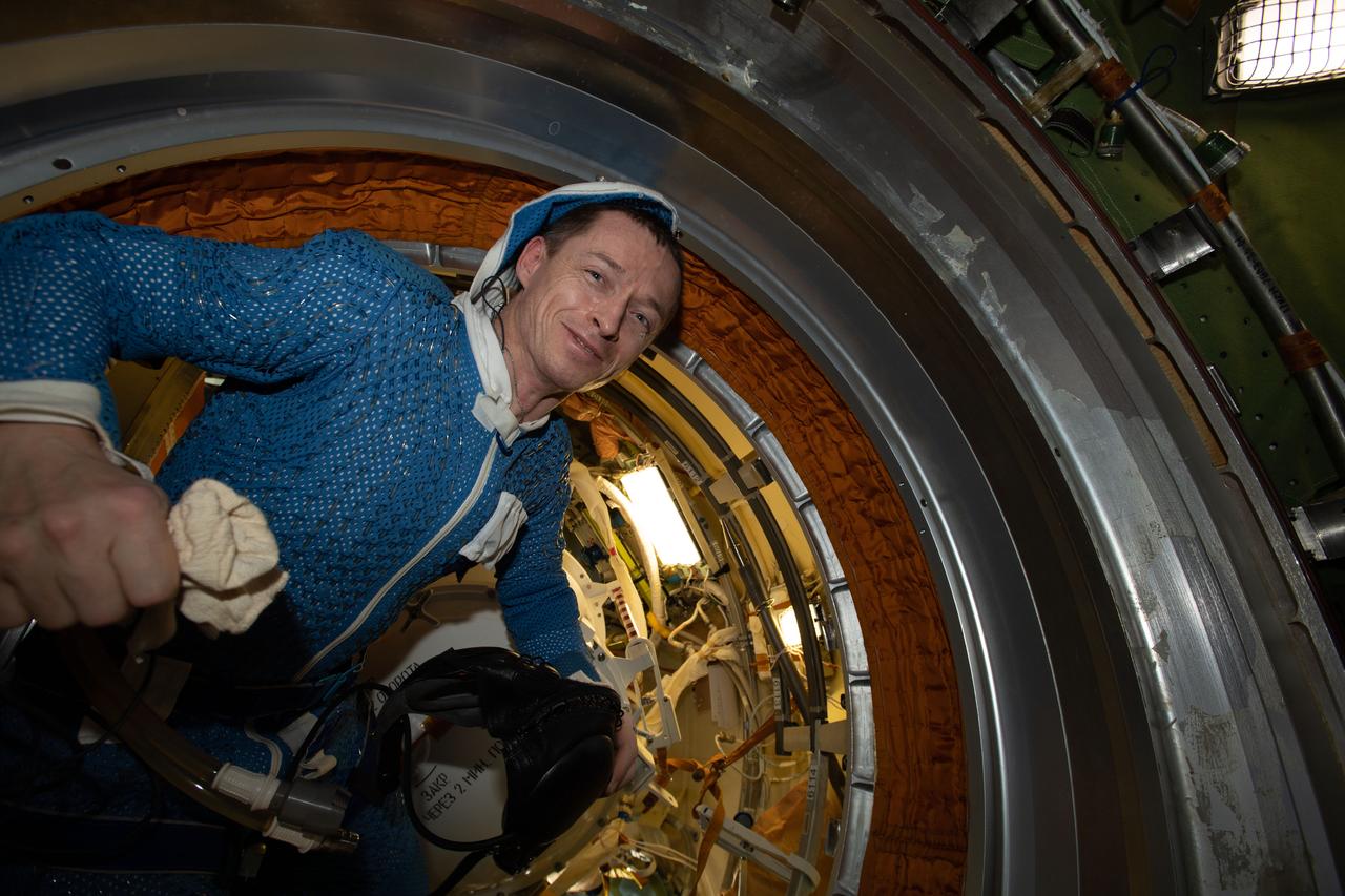 iss064e004959 (Nov. 20, 2020) --- Expedition 64 Commander Sergey Ryzhikov of Roscosmos is pictured inside the Poisk module after completing a six-hour and 48-minute spacewalk to prepare the International Space Station for Russia's new Nauka multipurpose laboratory module.