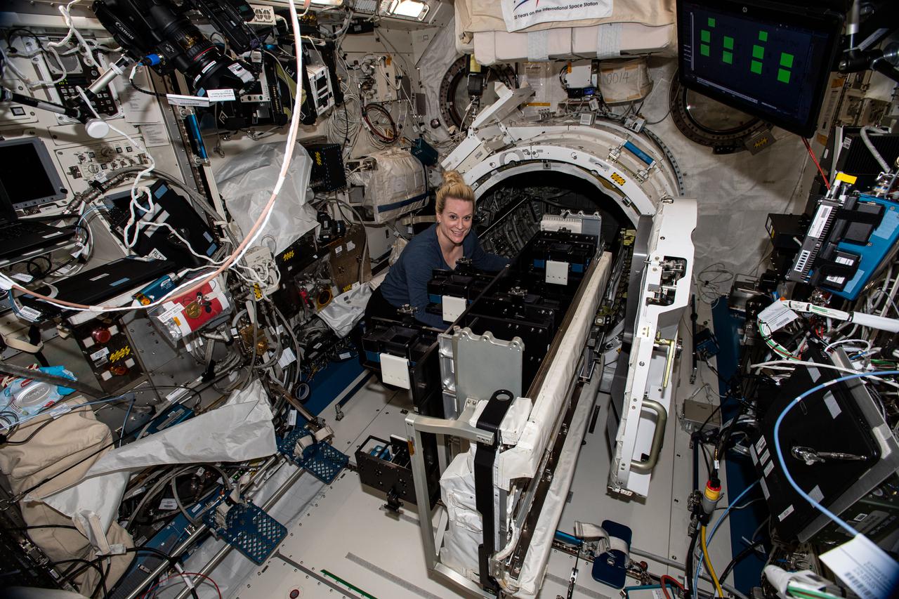 iss064e005561 (November 24, 2020) --- Flight Engineer Kate Rubins pauses for a photo during operations (OPS) to install MISSE (Materials International Space Station Experiment) Transfer Tray 2 (MTT 2) on the JEM (Japanese Experiment Module) Orbital Replacement Unit Transfer Interface (JOTI) attached to the JEM Airlock (JEMAL) Slide Table. Photo was taken in the Kibo JEM.