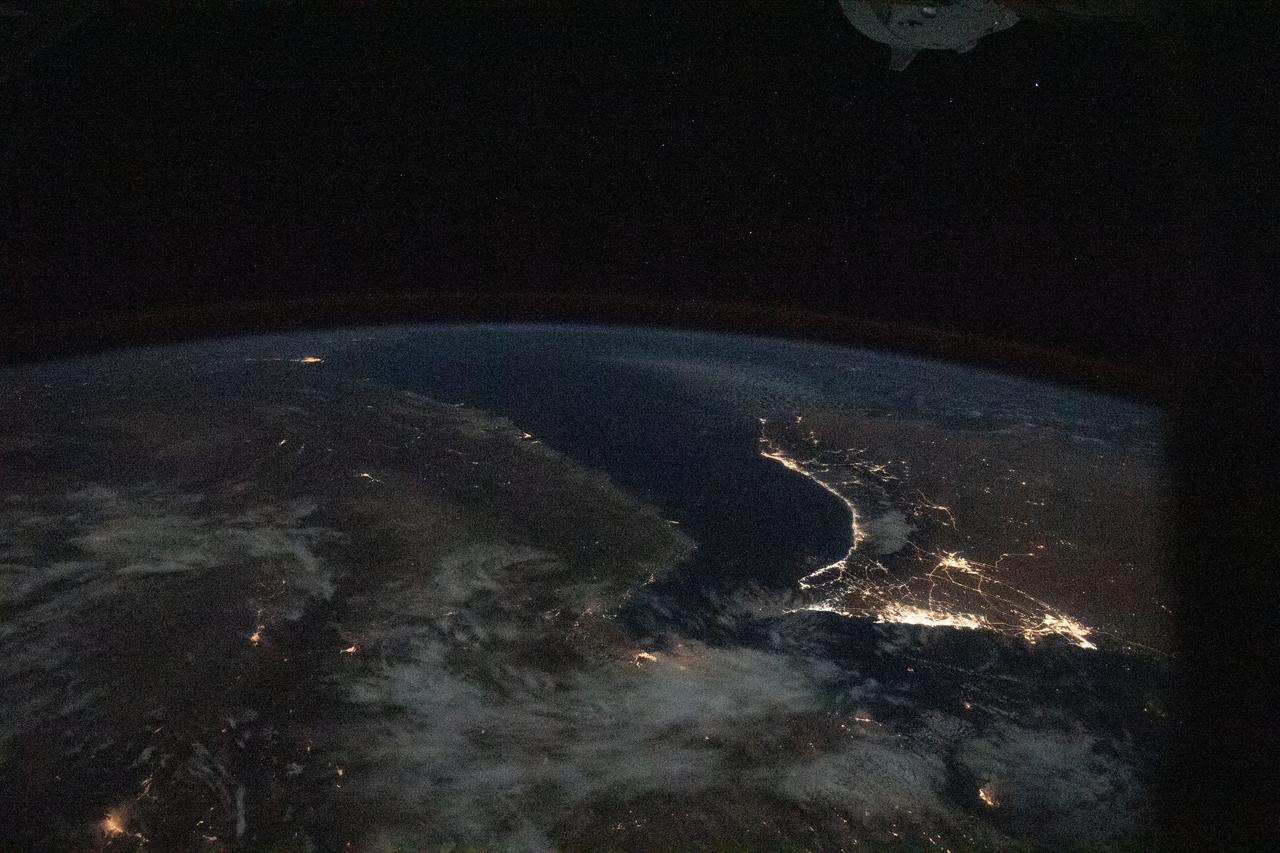 iss064e007913 (Nov. 28, 2020) --- This image from International Space Station as it was flying 261 miles over Iran looks southeast across the Persian Gulf and the Gulf of Oman. The well-lit areas along the coast are cities located in the nations of Oman and the United Arab Emirates.