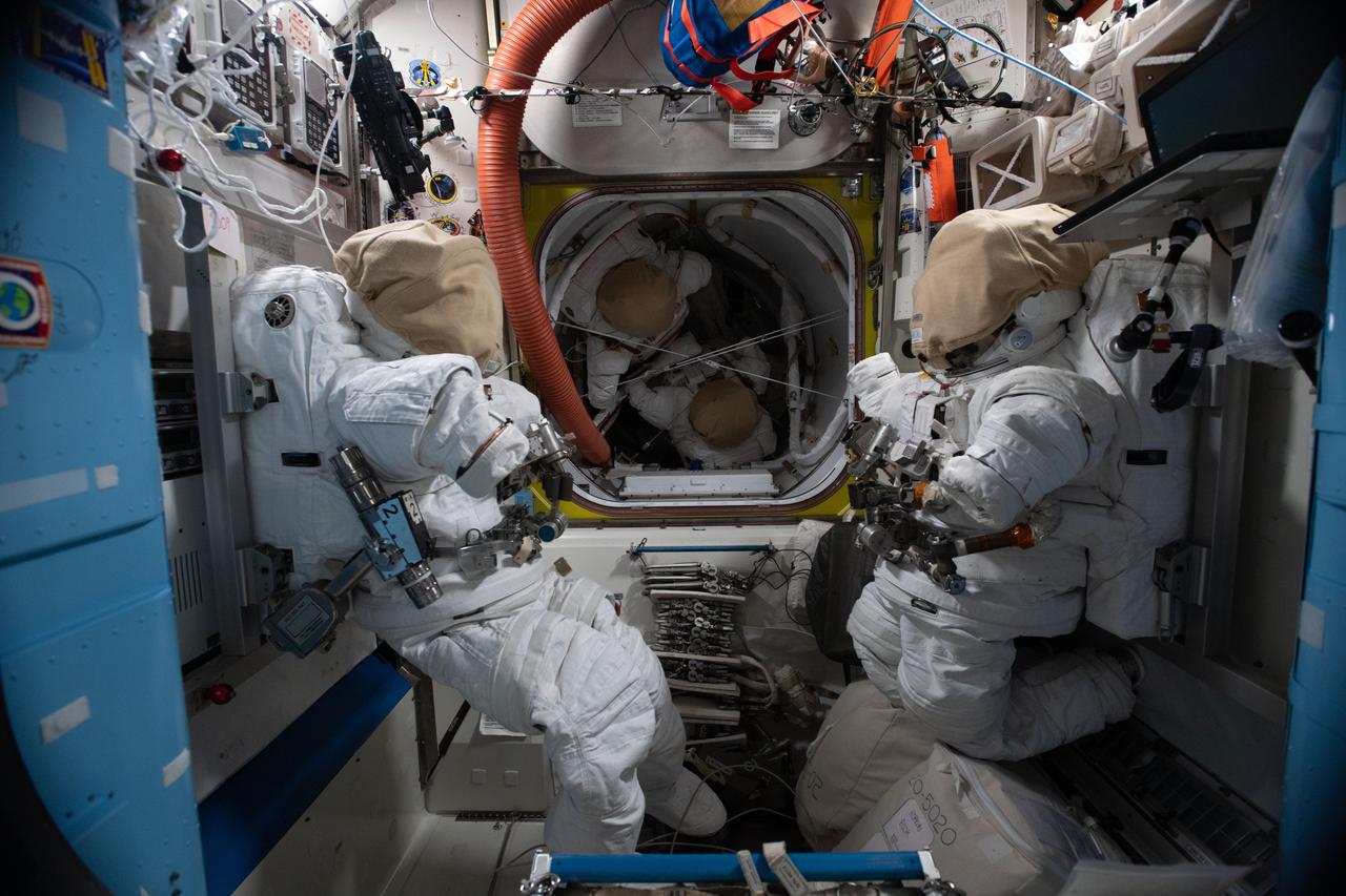 iss064e008969 (Dec. 2, 2020) --- Four U.S. spacesuits are pictured inside the International Space Station's Quest Joint airlock, including two in the equipment lock (foreground) and two in the crew lock (background).