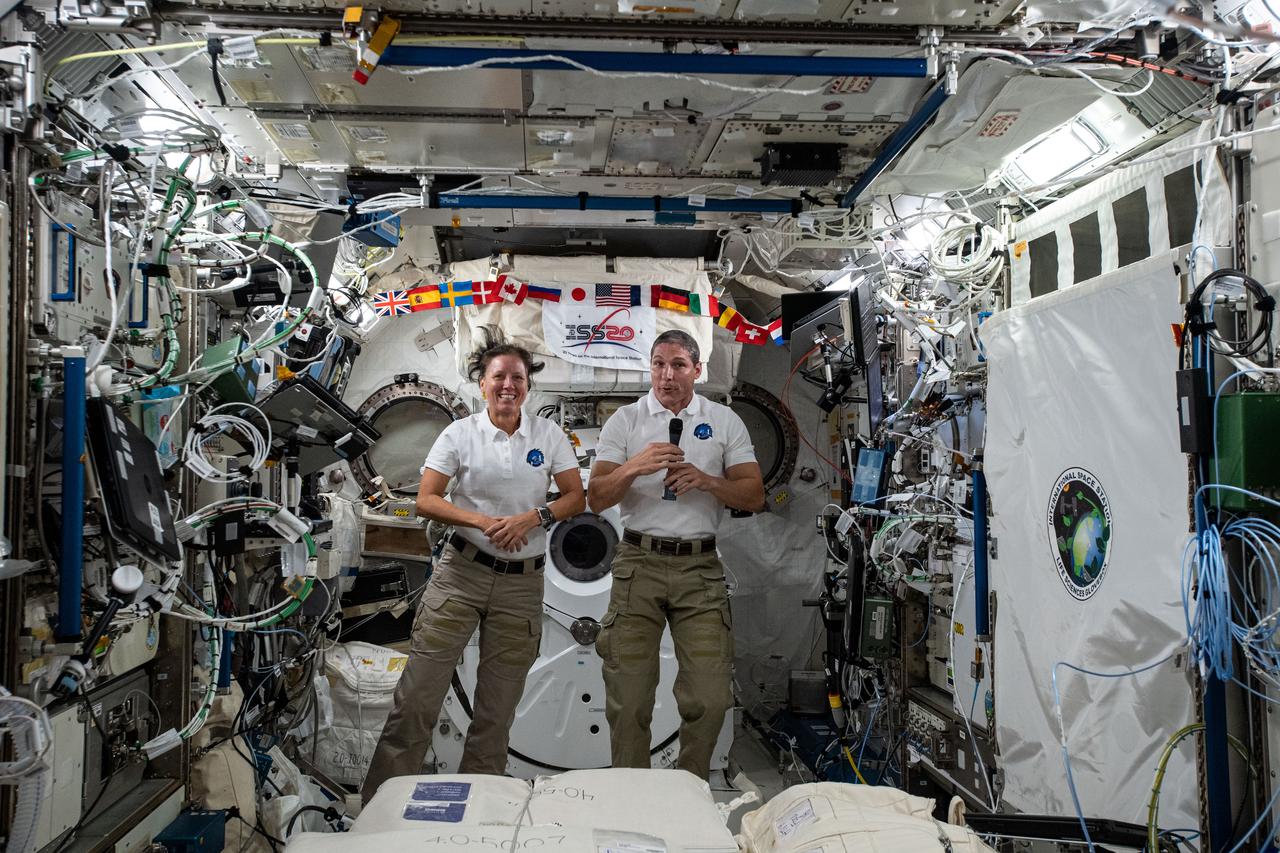 iss064e009702 (Dec. 4, 2020) --- NASA astronauts and Expedition 64 Flight Engineers Shannon Walker and Michael Hopkins are pictured in the Kibo laboratory module during a space-to-ground call with SpaceX personnel.