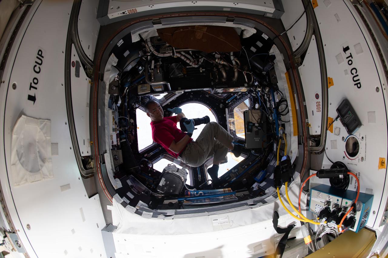 iss064e011424 (Dec. 9, 2020) --- JAXA (Japan Aerospace Exploration Agency) astronaut and Expedition 64 Flight Engineer Soichi Noguchi gives a "thumbs up" inside the seven-windowed cupola, the International Space Station's "window to the world."
