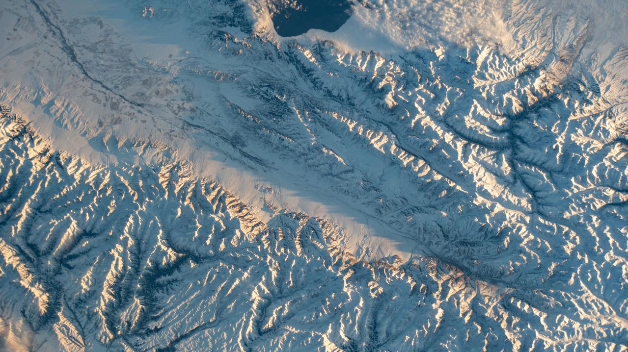 iss064e011823 (Dec. 11, 2020) --- Snow-covered mountains along the Kazakhstan-China border, including Sayram Lake at top, are pictured from the International Space Station as it orbited 263 miles above the Asian nations.