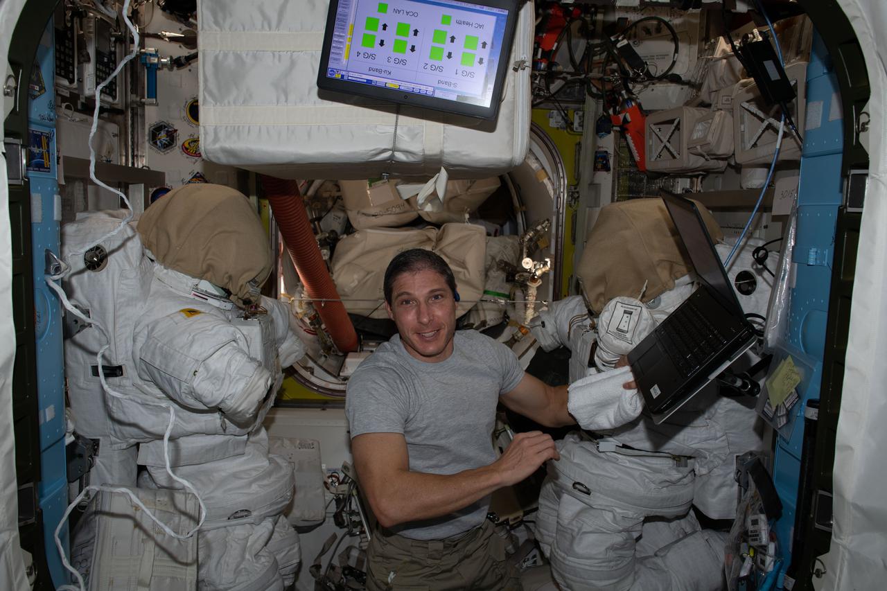 iss064e013338 (Dec. 17, 2020) --- Flight Engineer Michael Hopkins works inside the Quest airlock to prepare tools and U.S. spacesuits for planned spacewalks to continue maintenance on the outside of the International Space Station.