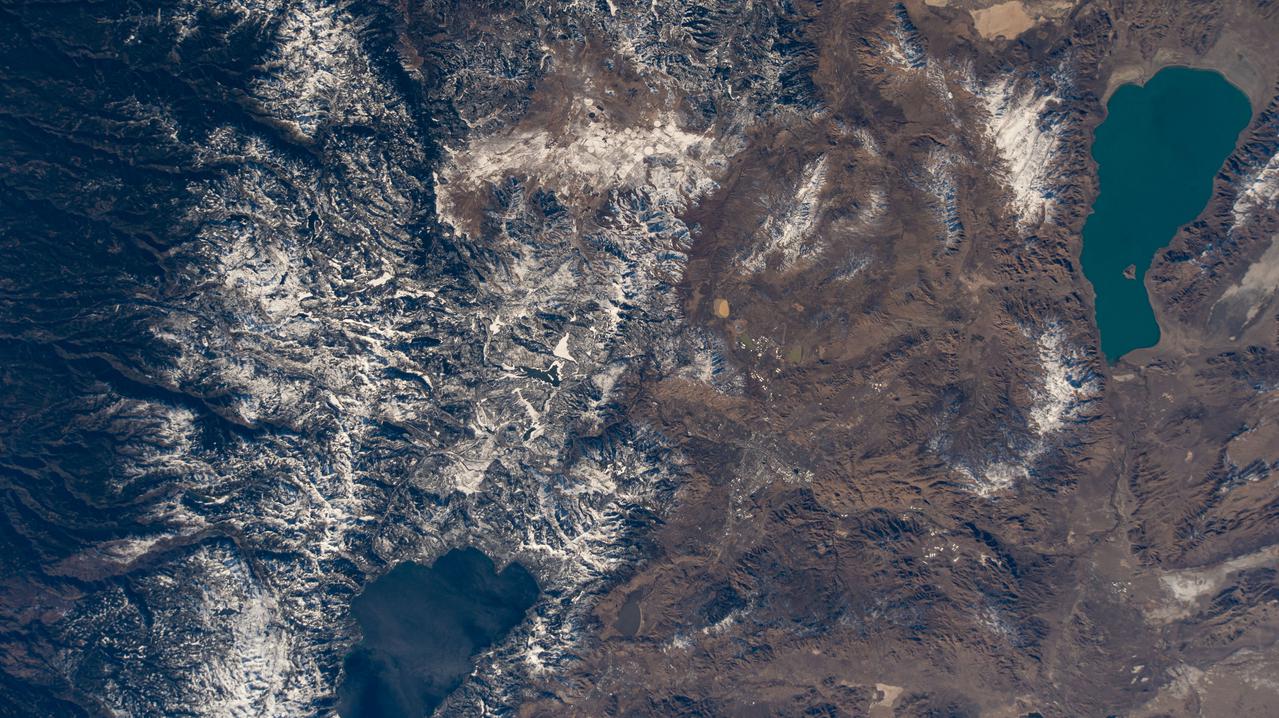 iss064e015104 (Dec. 23, 2020) --- Pyramid Lake (upper right) in Nevada; Lake Tahoe (lower left) in California; and the snow-capped Sierra Nevada mountains are pictured from the International Space Station as it was orbiting 262 miles above the southwestern United States.