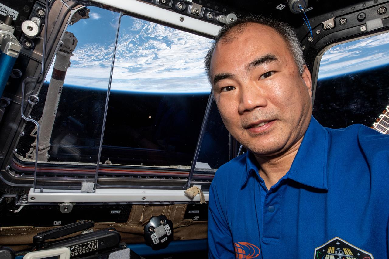 iss064e016183 (Dec. 27, 2020) --- JAXA astronaut Soichi Noguchi is pictured inside the International Space Station's "window to the world," the cupola, as it was orbiting 269 miles above the South Atlantic in between the tip of South America and the tip of South Africa.