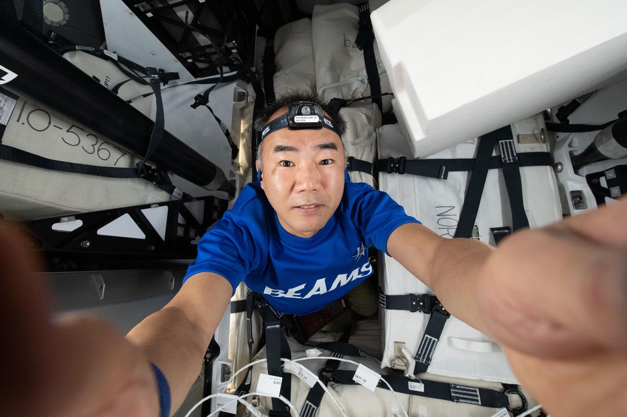 iss064e021855 (Jan. 10, 2021) --- Flight Engineer Soichi Noguchi of JAXA captures a "selfie" as he works to load cargo the inside SpaceX Cargo Dragon resupply ship before its undocking and departure from the International Space Station on Jan. 12.