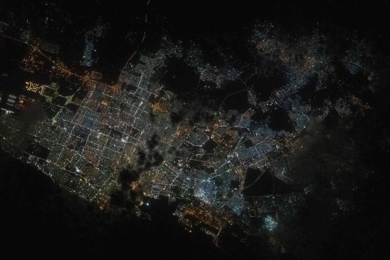 iss064e021924 (Jan. 9, 2021) ---Jeddah, Saudi Arabia, the desert nation's second-most populous city with 3.5 million residents, is pictured from the International Space Station as it orbited 261 miles above the Red Sea during a night time pass. The landmark towards the center left is the King Abdulaziz International Airport.