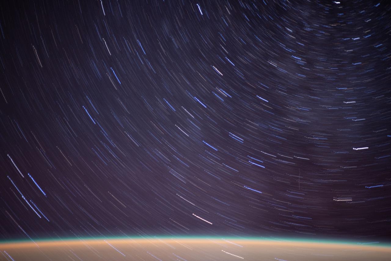 iss064e022729 (Jan. 12, 2021) --- This long duration photograph, taken from the International Space Station orbiting 263 miles above the Mediterranean Sea, shows streaks of a starry field above Earth's exaggerated atmospheric glow.