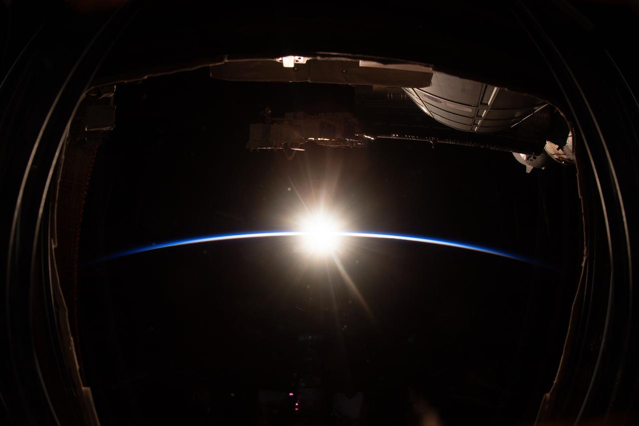 iss064e022835 (Jan. 13, 2021) --- This view from one of seven windows on the cupola shows an orbital sunrise as the International Space Station orbited 260 miles above the Pacific Ocean.