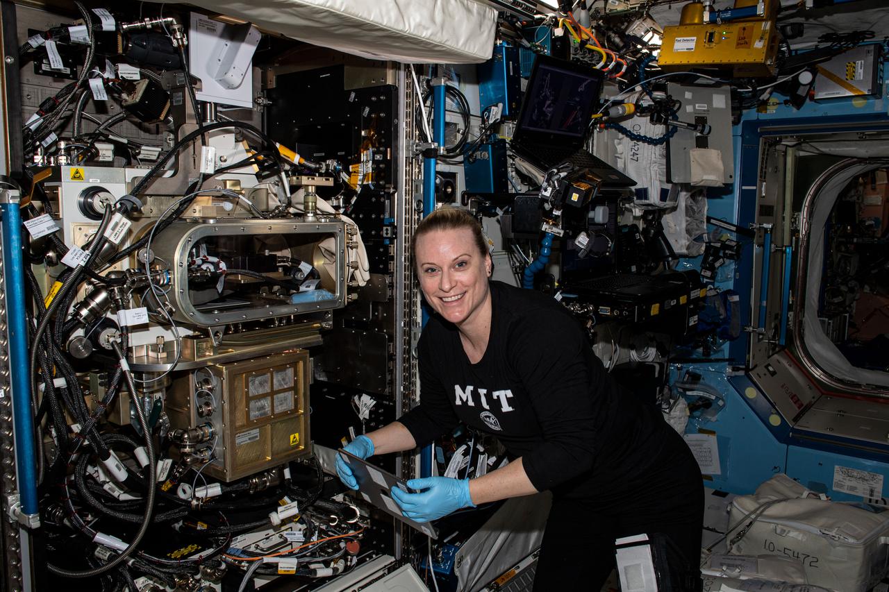 iss064e022911 (Jan. 14, 2021) --- NASA astronaut and Expedition 64 Flight Engineer Kate Rubins sets up the ACME (Advanced Combustion via Microgravity Experiments) study inside the U.S. Destiny laboratory module's Combustion Integrated Rack. ACME is a set of six independent studies exploring ways to increase fuel efficiency, reduce pollutants and improve fire safety on Earth and in space.