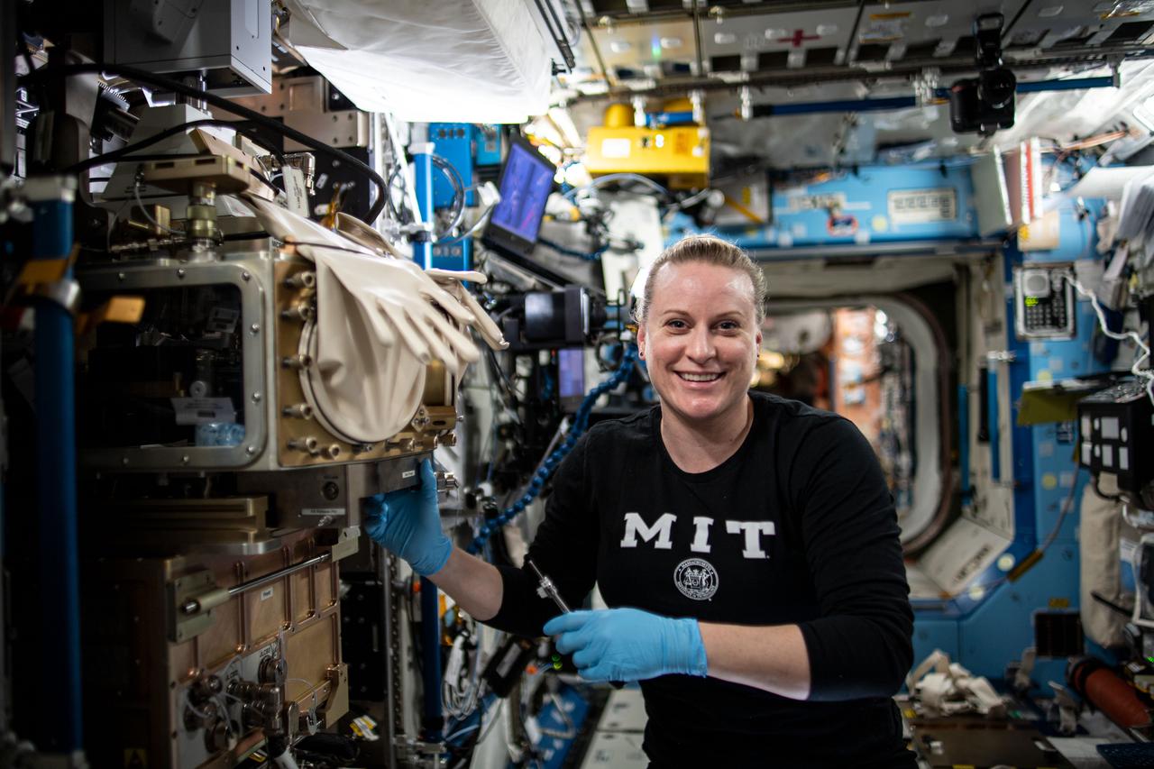 iss064e023935 (Jan. 14, 2021) --- NASA astronaut and Expedition 64 Flight Engineer Kate Rubins sets up the ACE-T-Ellipsoids study inside the Light Microscopy Module. The investigation designs and assembles complex three-dimensional colloids – small particles suspended within a fluid medium – and controls density and behavior of the particles with temperature.