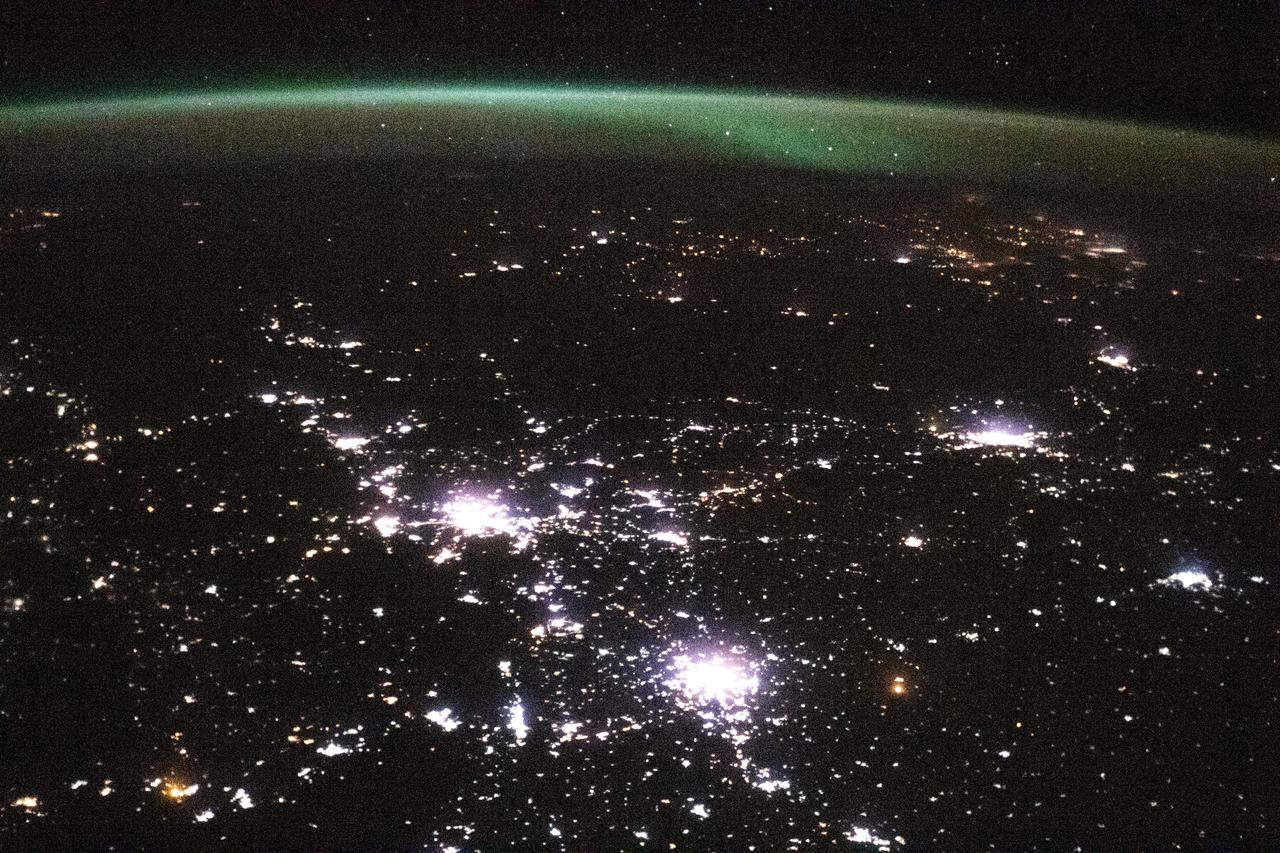 iss064e023201 (Jan. 13, 2021) --- This view from the International Space Station, as it orbited 264 miles above Kazakhstan, looks north towards Russia with its brightly lit cities blanketed by an aurora.