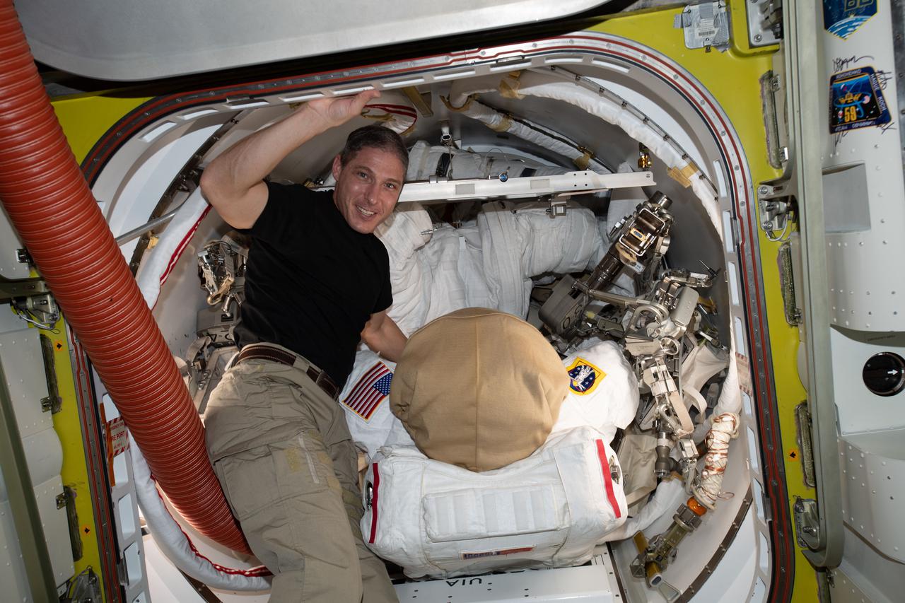 iss064e023916 (Jan. 18, 2021) --- NASA astronaut and Expedition 64 Flight Engineer Michael Hopkins works on U.S. spacesuit maintenance inside the Quest airlock of the International Space Station.