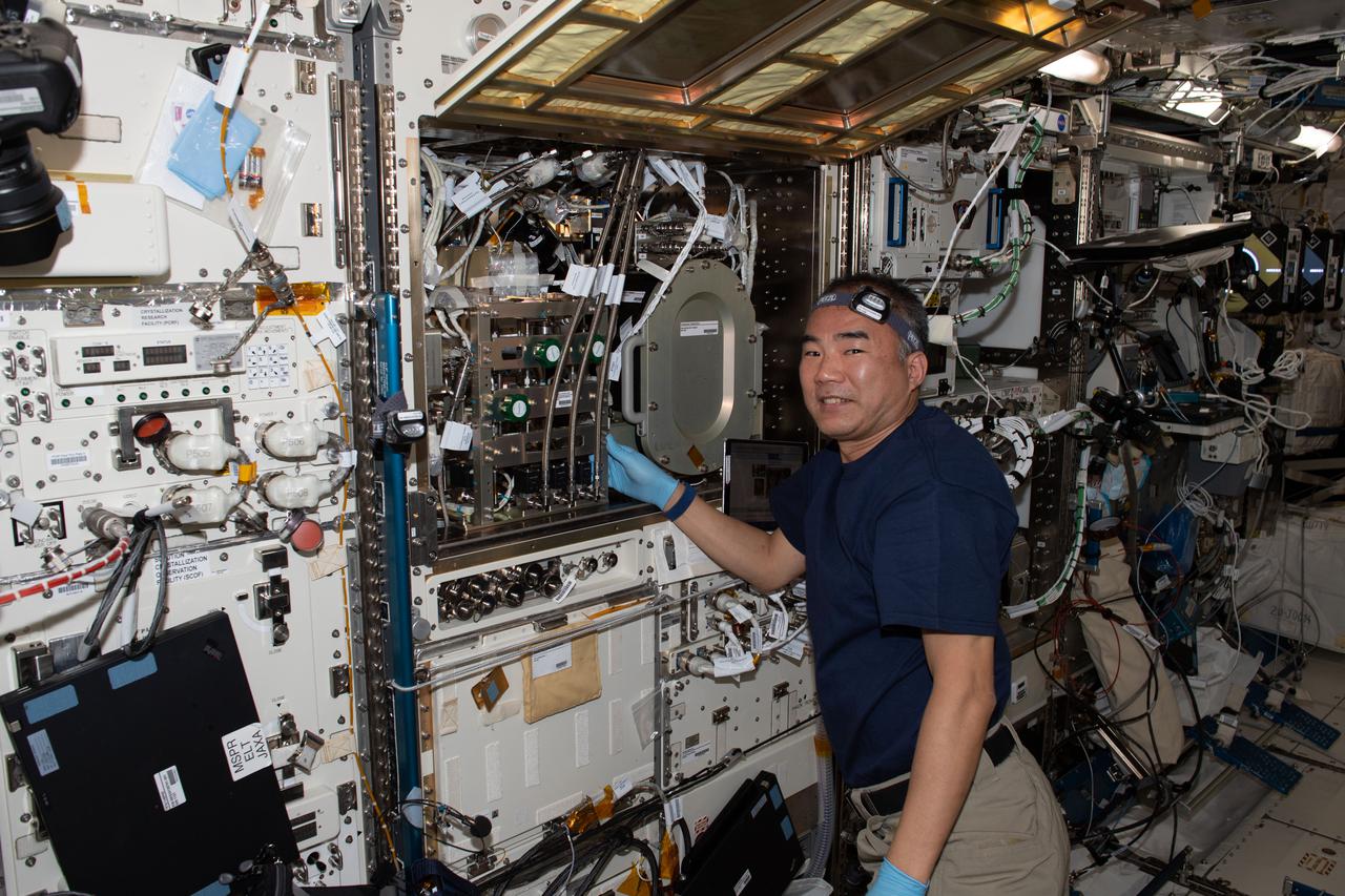 iss064e023901 (Jan. 19, 2021) --- JAXA astronaut and Expedition 64 Flight Engineer Soichi Noguchi works to install the Solid Combustion Experiment Module inside the Kibo laboratory module's Multipurpose Small Payload Rack.