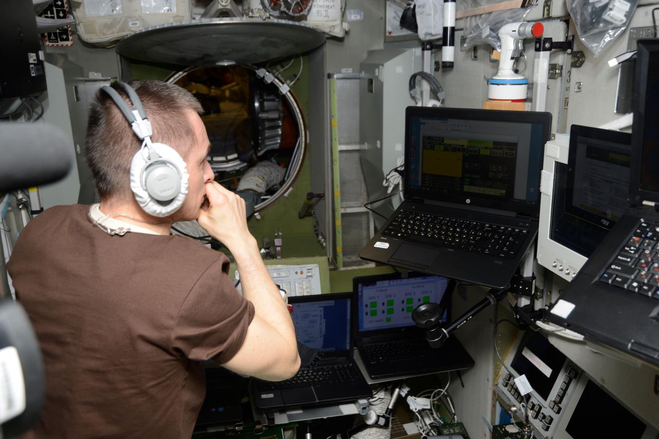 iss064e024157 (Jan. 19, 2021) --- Roscosmos cosmonaut and Expedition 64 Commander Sergey Ryzhikov reviews emergency escape procedures on a computer in the unlikely event the crew would have to evacuate the station and quickly undock inside their Soyuz crew ship.
