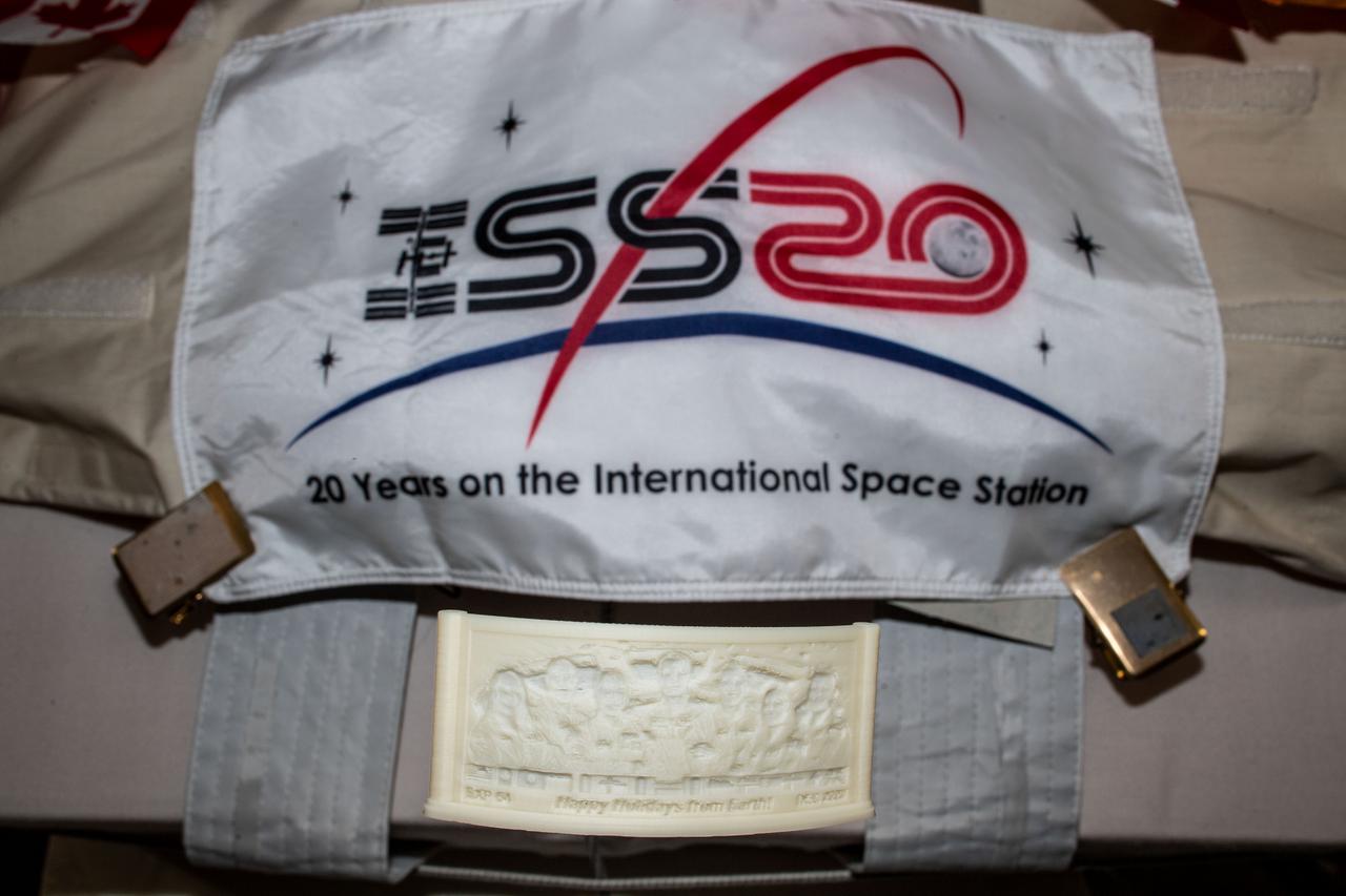  iss064e024274 (1/20/2021) --- A view of the Year 2020 Print, printed in the Additive Manufacturing Facility (AMF) Manufacturing Device (ManD) and floating near the ISS20 Banner in the Kibo Japanese Experiment Module (JEM) aboard the International Space Station (ISS). The Bellevue High School 2020 Print project uses the space station’s Manufacturing Device – Additive Manufacturing Facility (AMF) to provide students a behind-the-scenes experience with the 3D prinitng process in microgravity.