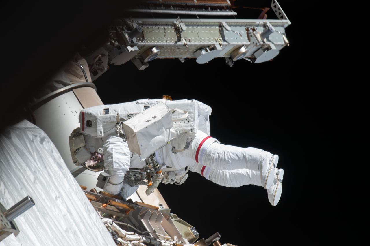 iss064e027044 (Jan. 27, 2021) --- NASA spacewalker and Expedition 64 Flight Engineer Michael Hopkins works to ready the International Space station's port-side truss structure for future solar array upgrades.