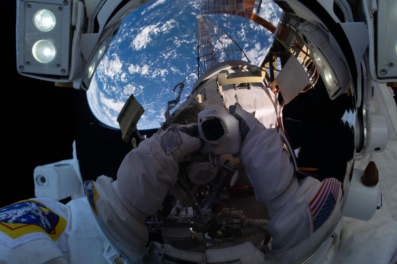 iss064e027922 (Feb. 1, 2021) --- NASA astronaut Michael Hopkins points his camera, insulated from the harmful environment of space, toward his spacesuit helmet's reflective shield and takes an out-of-this-world "space-selfie" during a spacewalk he conducted with fellow NASA astronaut Victor Glover (out of frame).