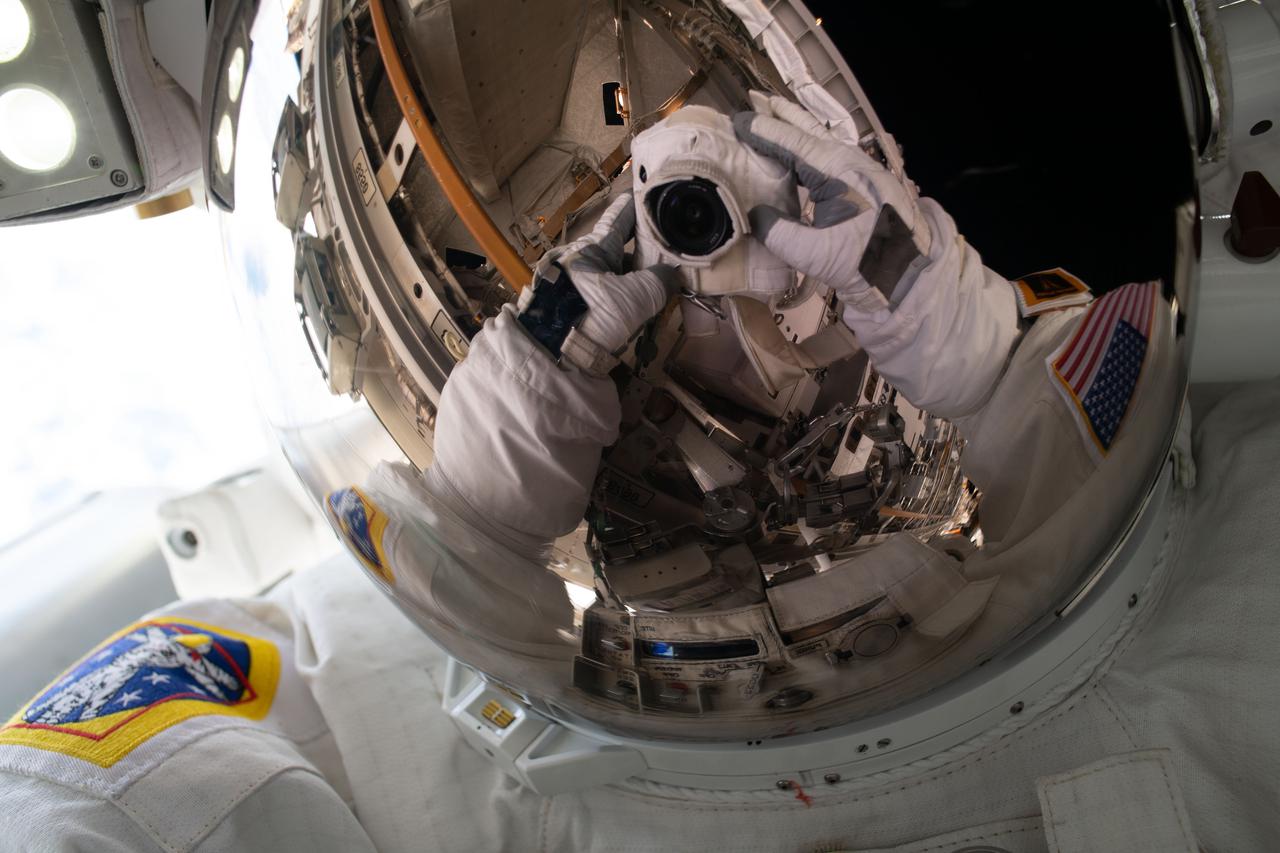 iss064e027943 (Feb. 1, 2021) --- NASA astronaut Michael Hopkins points his camera, insulated from the harmful environment of space, toward his spacesuit helmet's reflective shield and takes an out-of-this-world "space-selfie" during a spacewalk he conducted with fellow NASA astronaut Victor Glover (out of frame).
