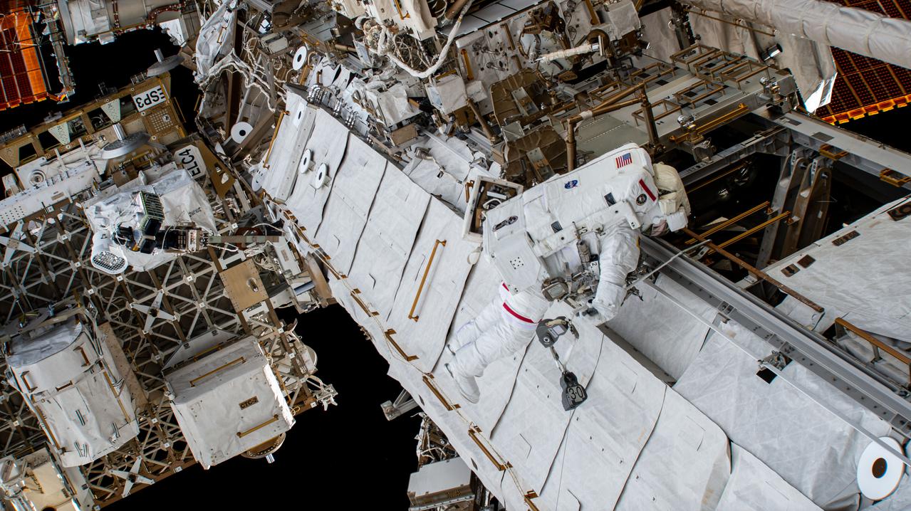 iss064e029012 (Feb. 1, 2021) --- NASA astronaut Michael Hopkins works during a spacewalk to complete battery upgrade work on the outside of the International Space Station with fellow NASA astronaut Victor Glover (out of frame).