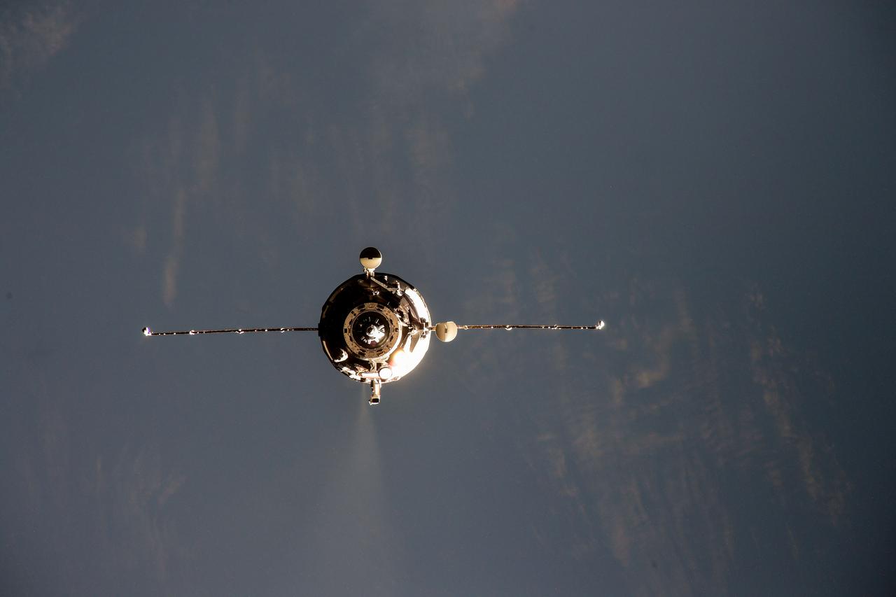 iss064e033741 (Feb. 17, 2021) --- Russia's uncrewed ISS Progress 77 resupply ship is pictured approaching its docking port on the International Space Station's Pirs docking compartment. A thruster is seen firing during an "impulse" burn to fine tune the spacecraft's path toward its docking port.
