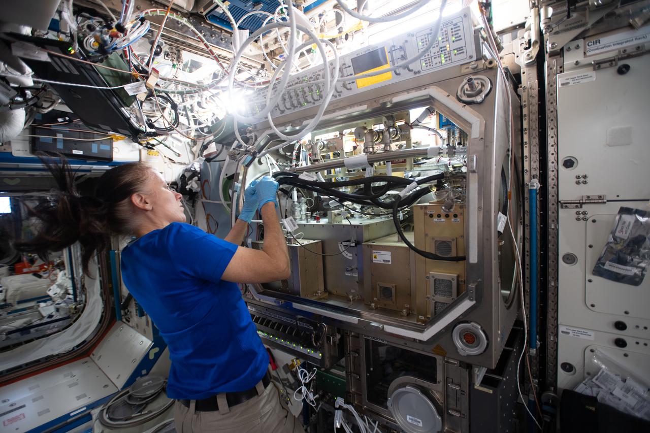 iss064e035056 (Feb. 19, 2021) --- NASA astronaut and Expedition 64 Flight Engineer Shannon Walker sets up Packed Bed Reactor Experiment (PBRE) hardware components inside the Destiny laboratory module's Microgravity Science Glovebox. The PBRE study explores how liquids and gases in behave together microgravity which may enable the design of more efficient, lightweight thermal management and life support systems that use less energy on future space exploration missions.