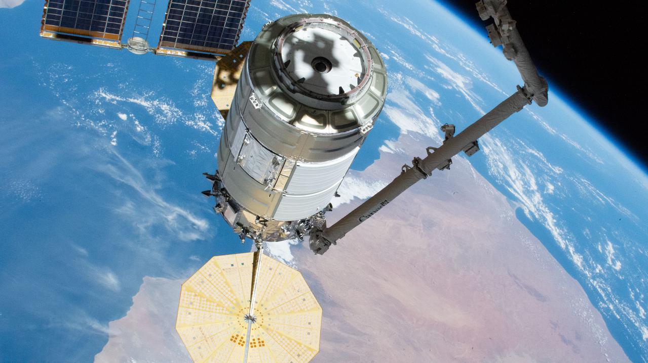 iss064e035920 (Feb. 22, 2021) --- The Cygnus space freighter from Northrop Grumman is maneuvered in the grip of the Canadarm2 robotic arm toward its port on the Unity module where it will stay until late May. The International Space Station was orbiting 262 miles above Ethiopia at the time this photograph was taken.