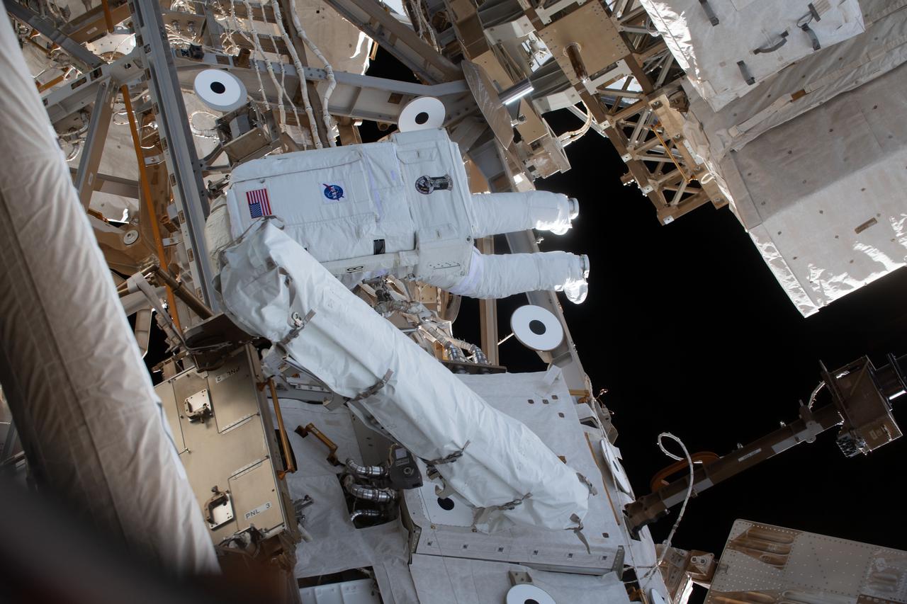 iss064e038273 (Feb. 28, 2021) --- NASA astronaut Victor Glover is pictured during a spacewalk to install solar array modification kits on the International Space Station. The maintenance work will support new, more powerful solar arrays that will be delivered on upcoming SpaceX Dragon cargo missions.