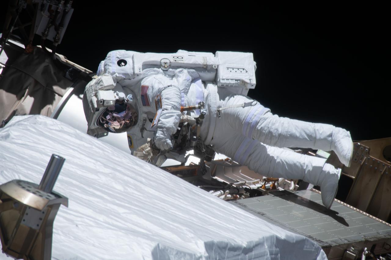iss064e038332 (Feb. 28, 2021) --- NASA astronaut Victor Glover is pictured during a spacewalk to install solar array modification kits on the International Space Station. The maintenance work will support new, more powerful solar arrays that will be delivered on upcoming SpaceX Dragon cargo missions.