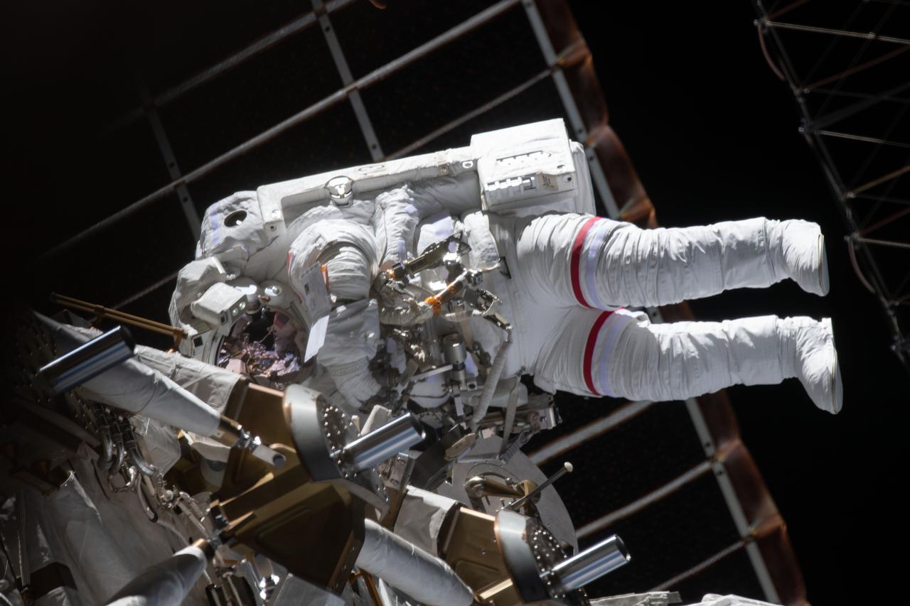 iss064e038485 (Feb. 28, 2021) --- NASA astronaut Kate Rubins is pictured during a spacewalk to install solar array modification kits on the International Space Station. The maintenance work will support new, more powerful solar arrays that will be delivered on upcoming SpaceX Dragon cargo missions.