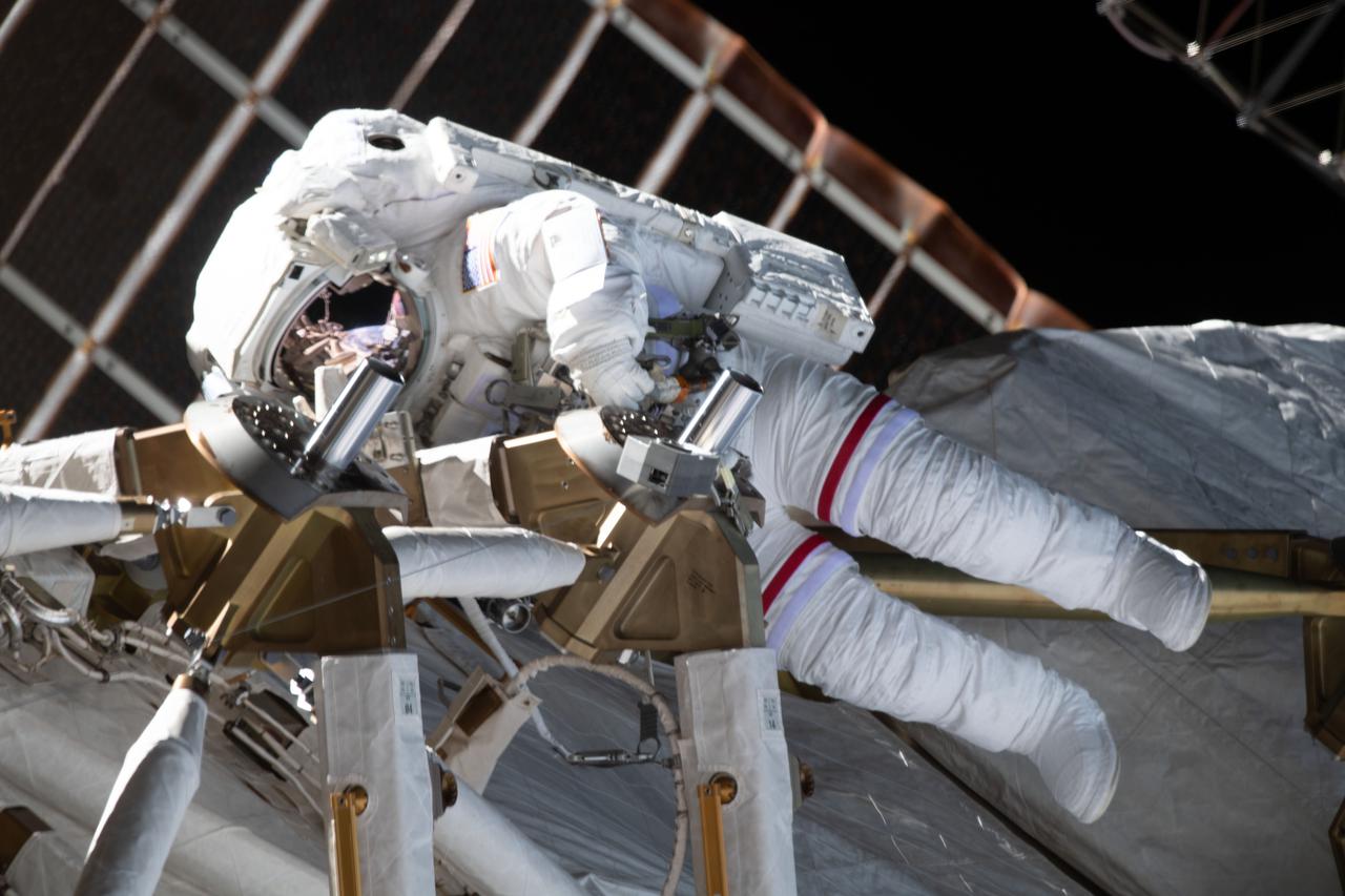 iss064e038494 (Feb. 28, 2021) --- NASA astronaut Kate Rubins is pictured during a spacewalk to install solar array modification kits on the International Space Station. The maintenance work will support new, more powerful solar arrays that will be delivered on upcoming SpaceX Dragon cargo missions.