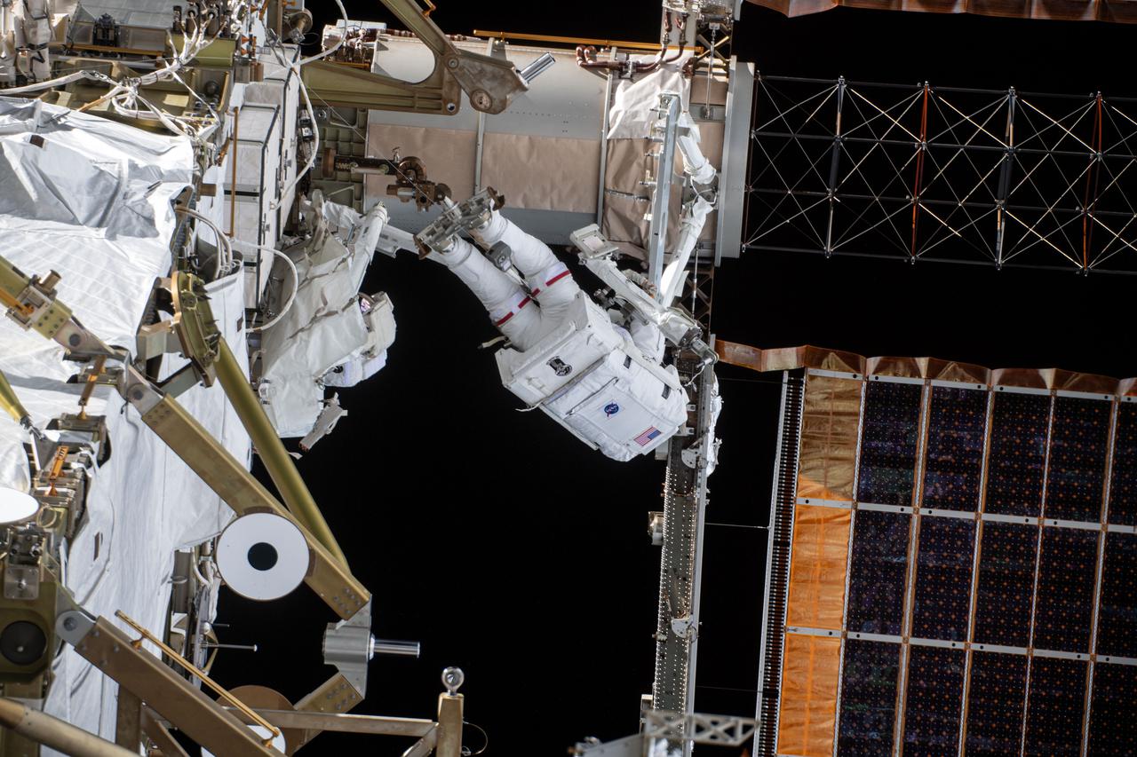 iss064e039836 (March 5, 2021) --- NASA astronaut Kate Rubins is pictured during a spacewalk to install solar array modification kits to ready the International Space Station for newer, more powerful solar arrays being delivered on upcoming SpaceX Dragon cargo missions.